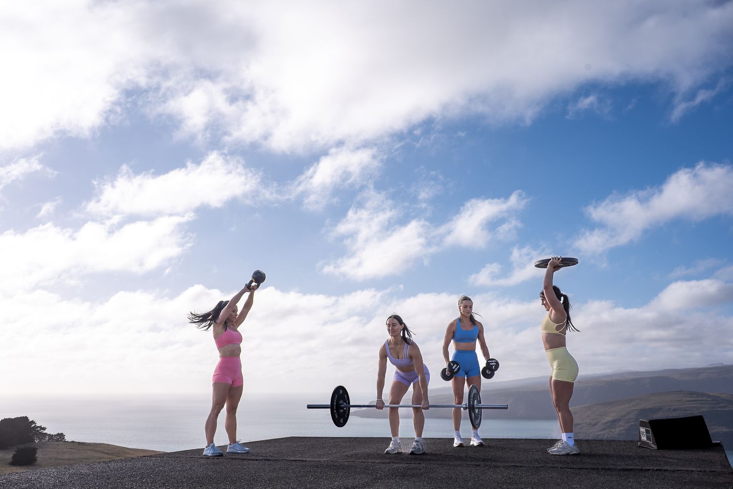 Silhouetted figures stand on a mountain ridge against a dramatic cloudy sky during a scenic hike.