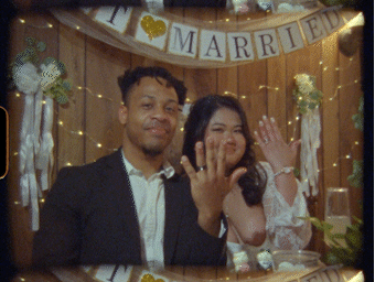 Wedding guests celebrate and dance together during a joyful reception under warm string lights.