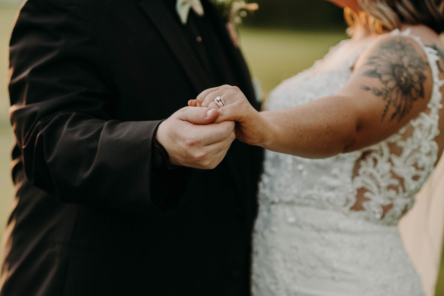 Close-up of hands exchanging rings during an intimate wedding ceremony.