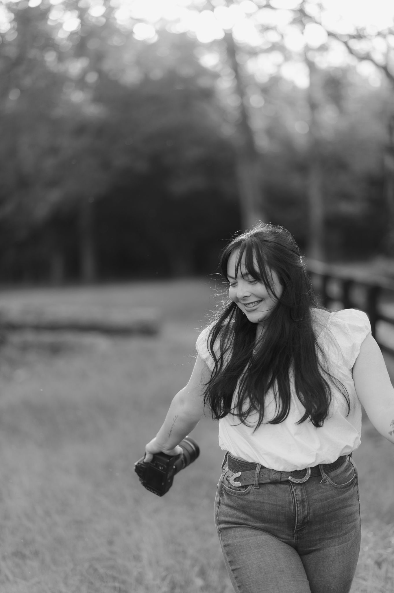 Black and white outdoor portrait session in a grassy field.