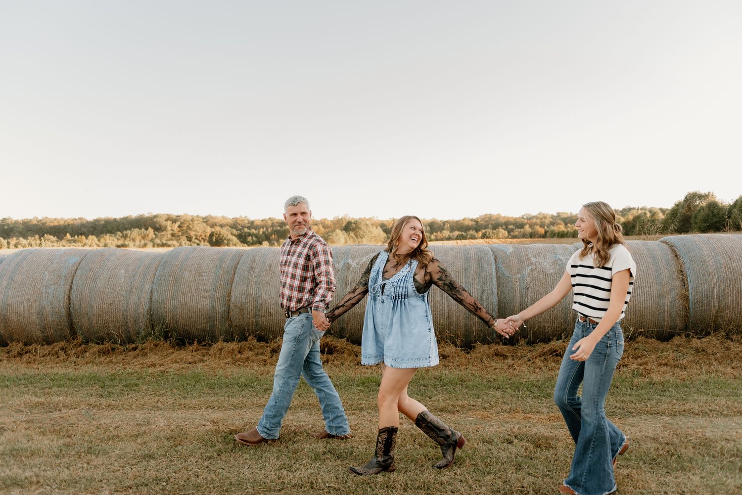 Playful family moments captured in a rustic farm setting at golden hour.