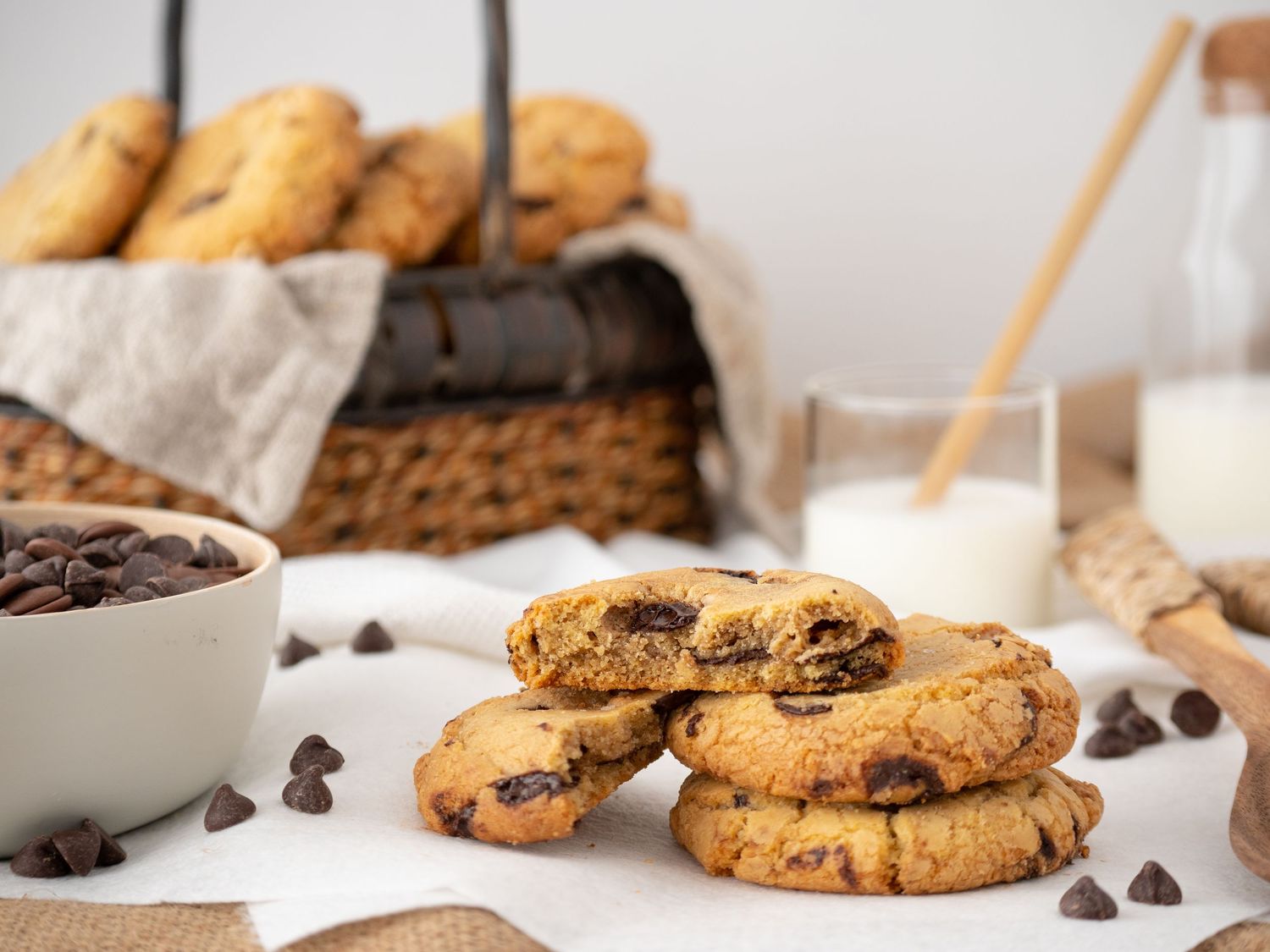 Close-up shots of homemade chocolate chip cookies with scattered chocolate chips on white surface.