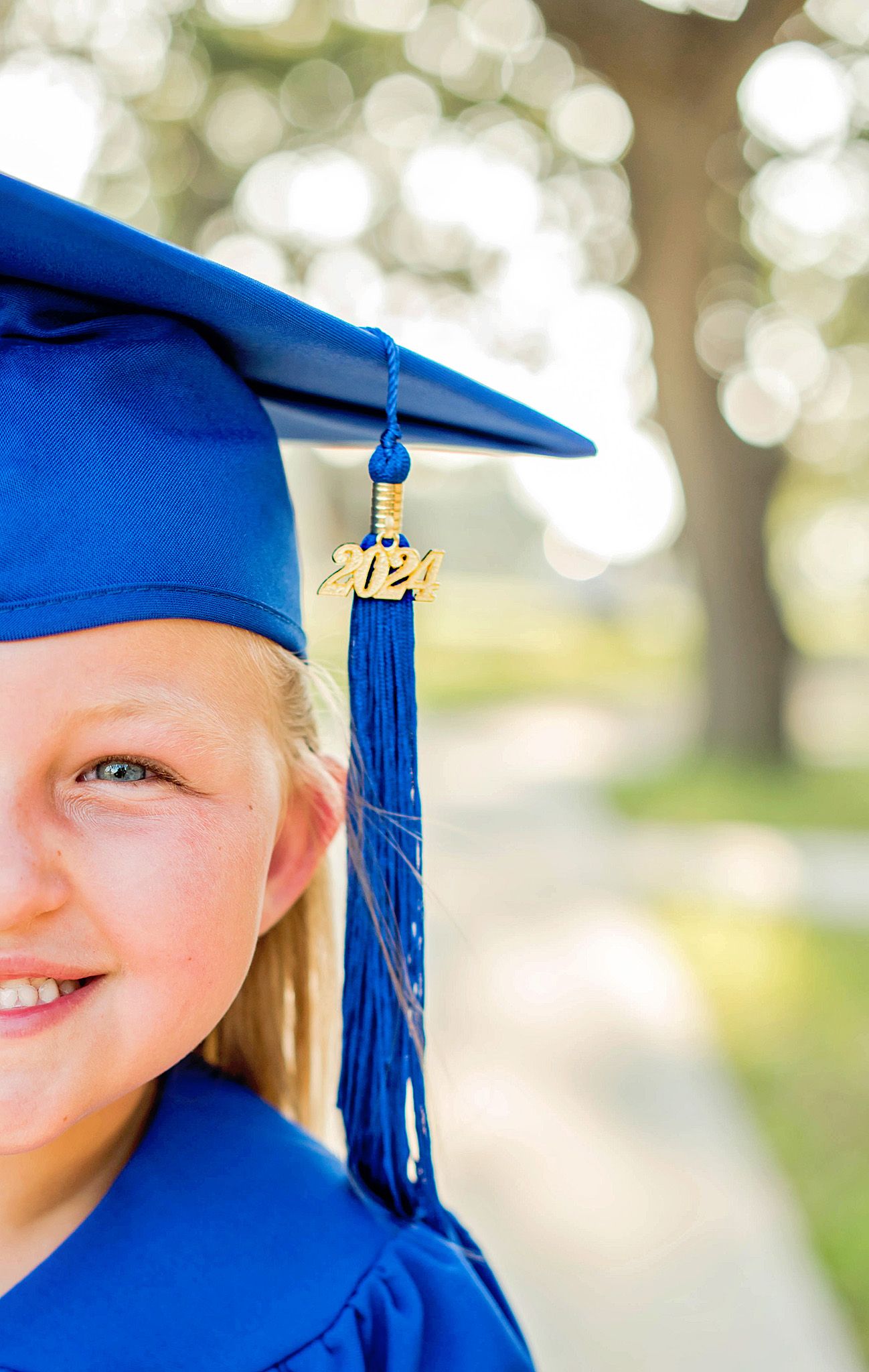 Graduation portrait series showing close-up details of blue cap and gown with gold tassel against soft bokeh background.