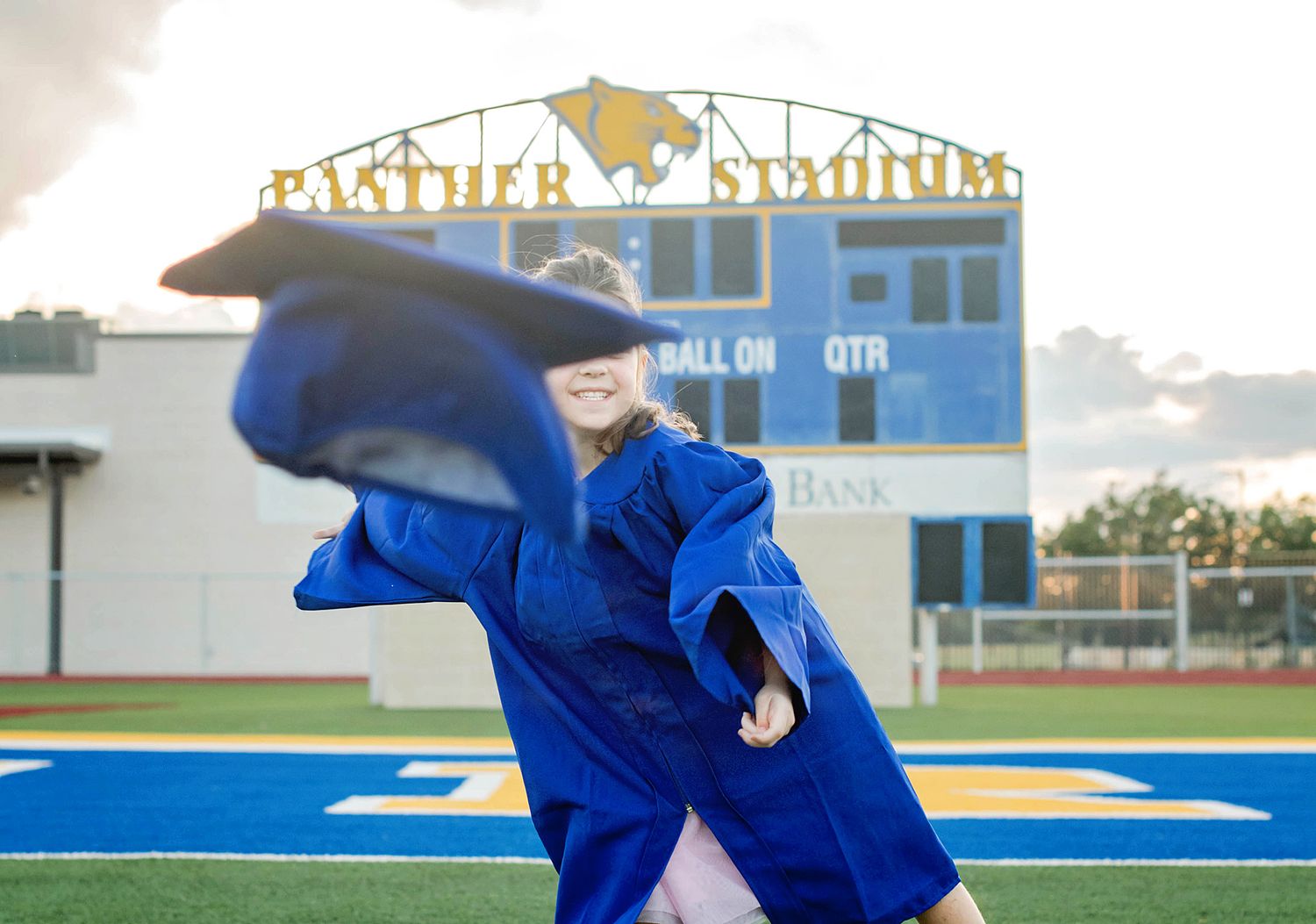Athletes in blue uniforms demonstrate judo throws and techniques on an outdoor sports field.