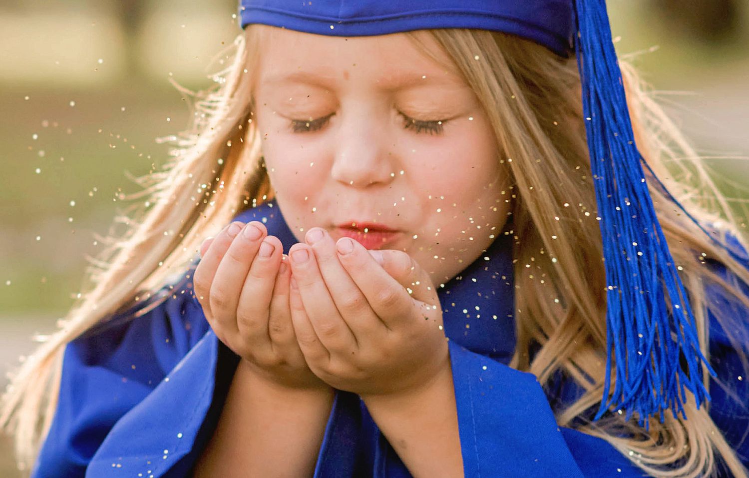 A sequence of photos shows someone in blue graduation attire blowing glitter and sparkles into the air.