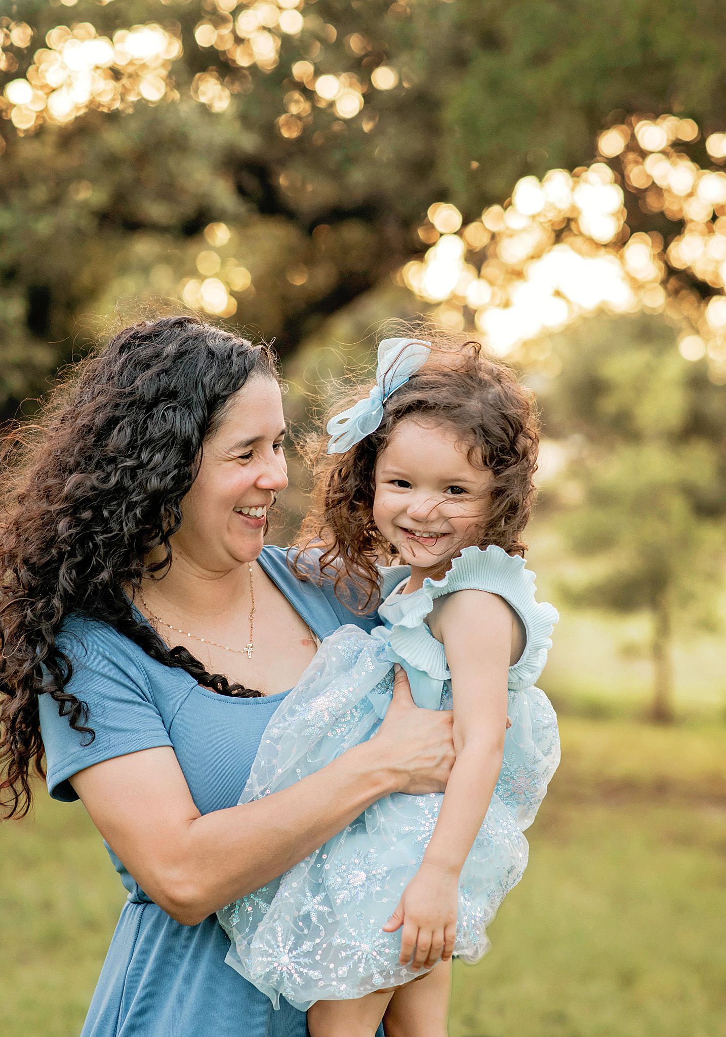 A heartwarming series of candid moments between two people in blue outfits against a sunlit outdoor backdrop in Blanco, TX.