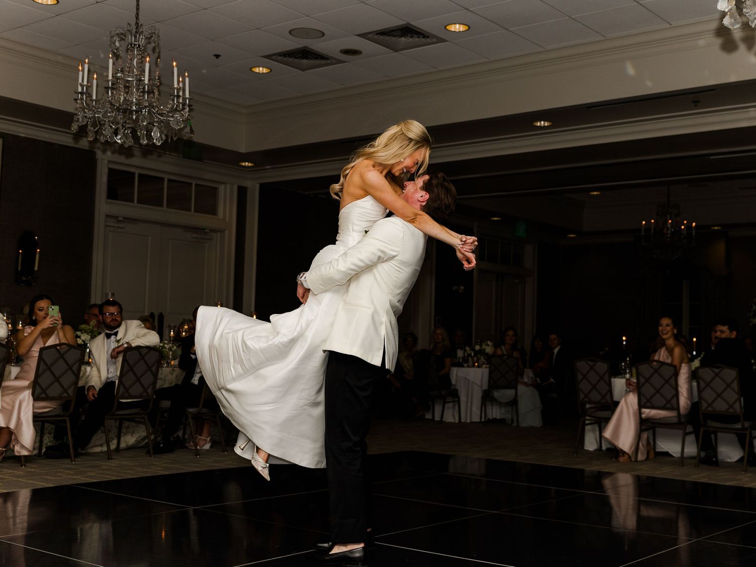 Wedding reception dance floor moments captured in low light.
