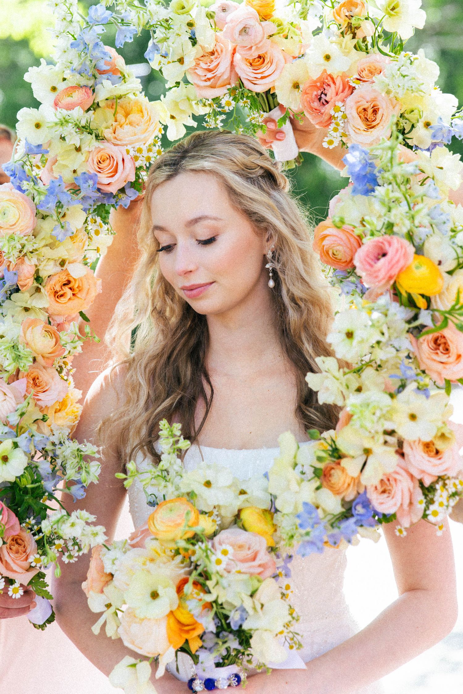 Ethereal spring floral crown with peach roses and delicate white blooms.