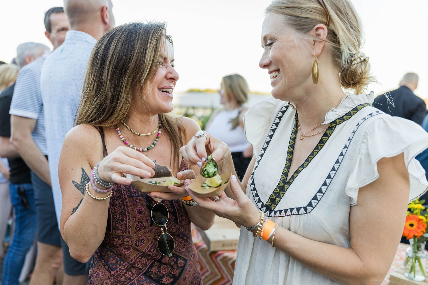 Wedding guests enjoying appetizers and conversation at an elegant outdoor reception.