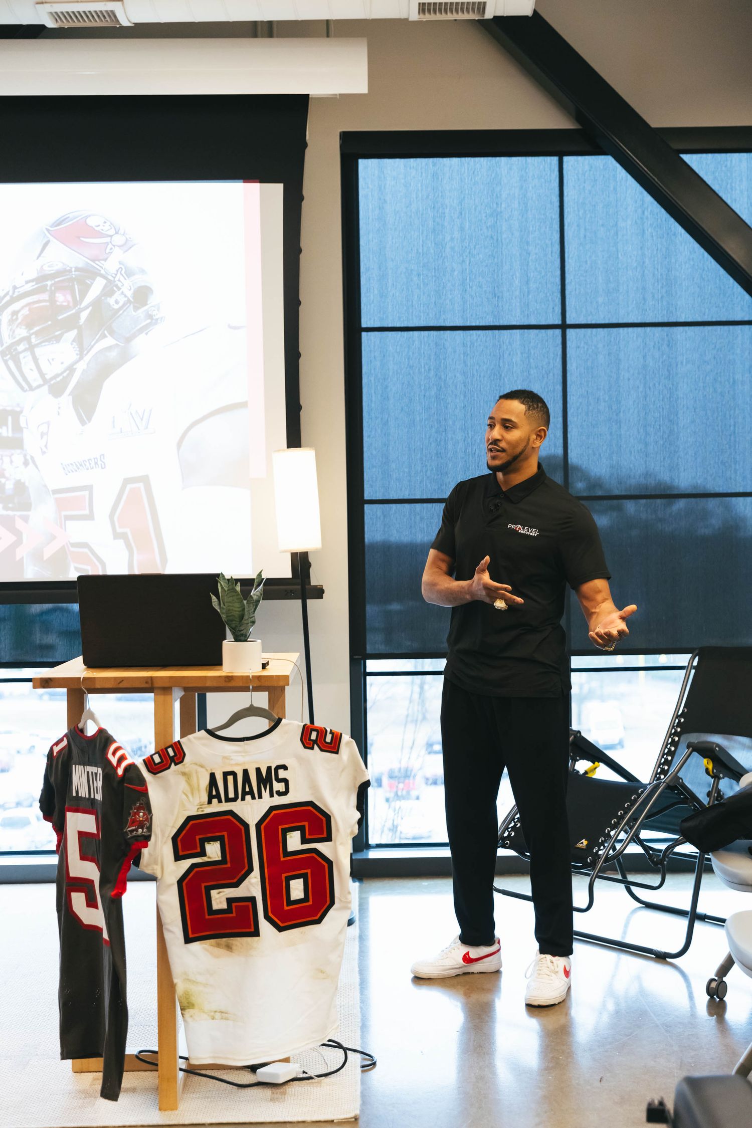 Sports memorabilia presentation with jerseys and equipment displayed in a modern office space.