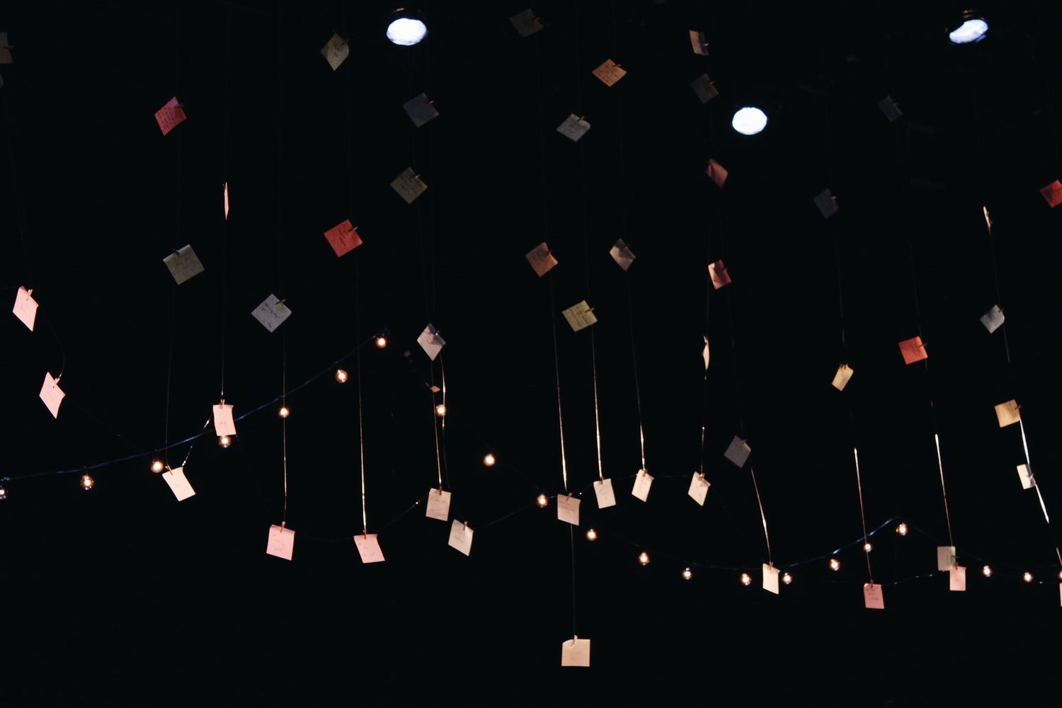Paper lanterns and decorative elements suspended from ceiling in dim lighting.