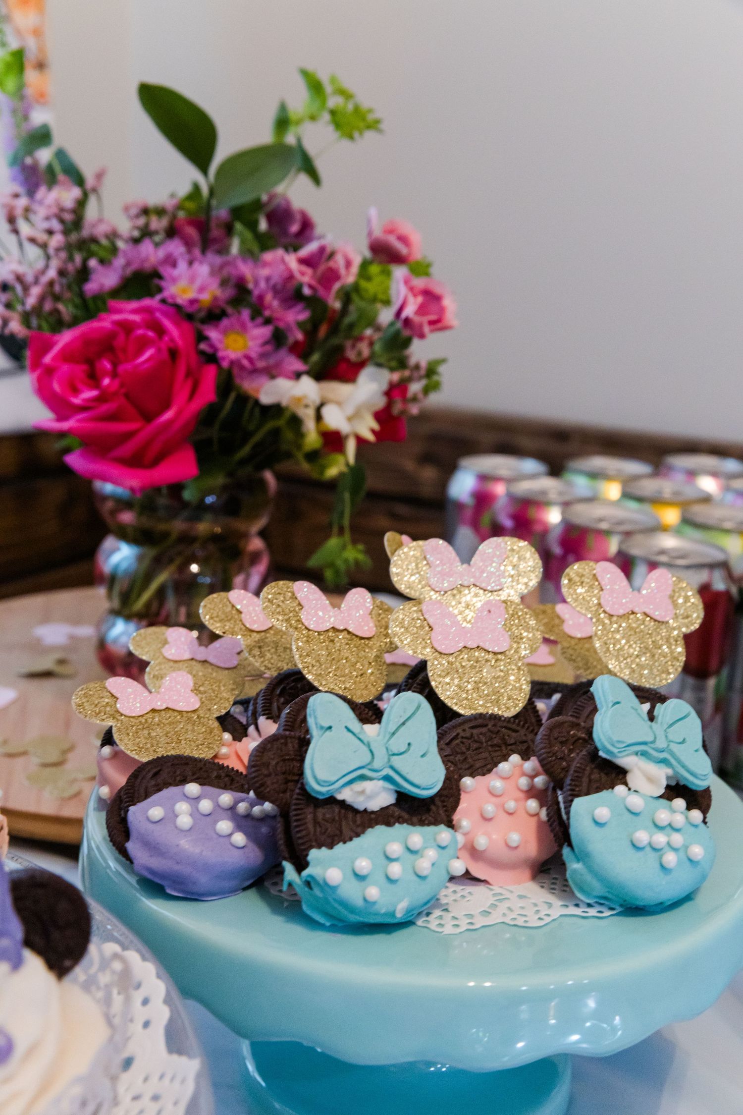 Disney-themed dessert display with pink and blue Minnie Mouse cake decorations.