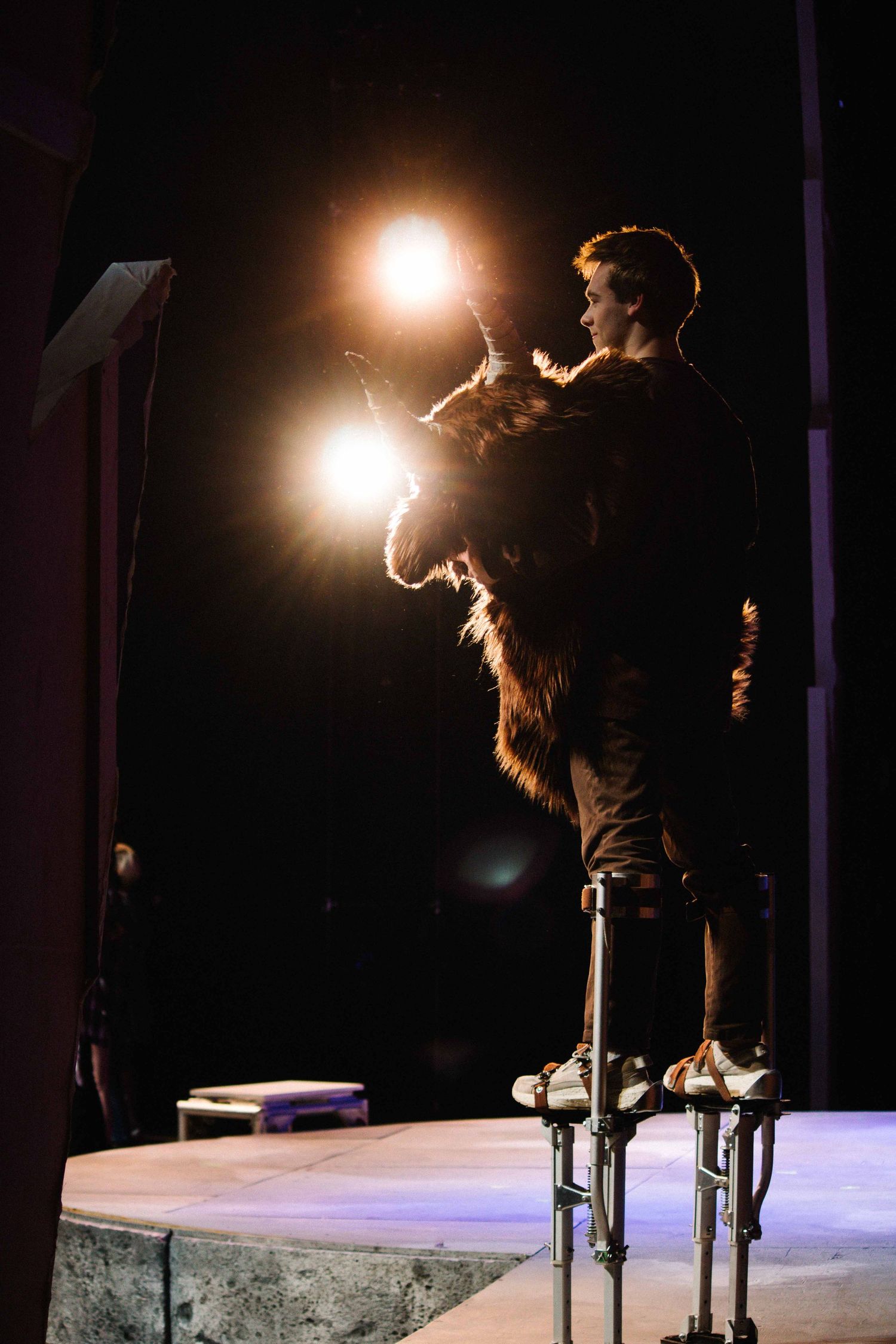 Silhouetted performer on stage with dramatic backlighting during a concert performance.