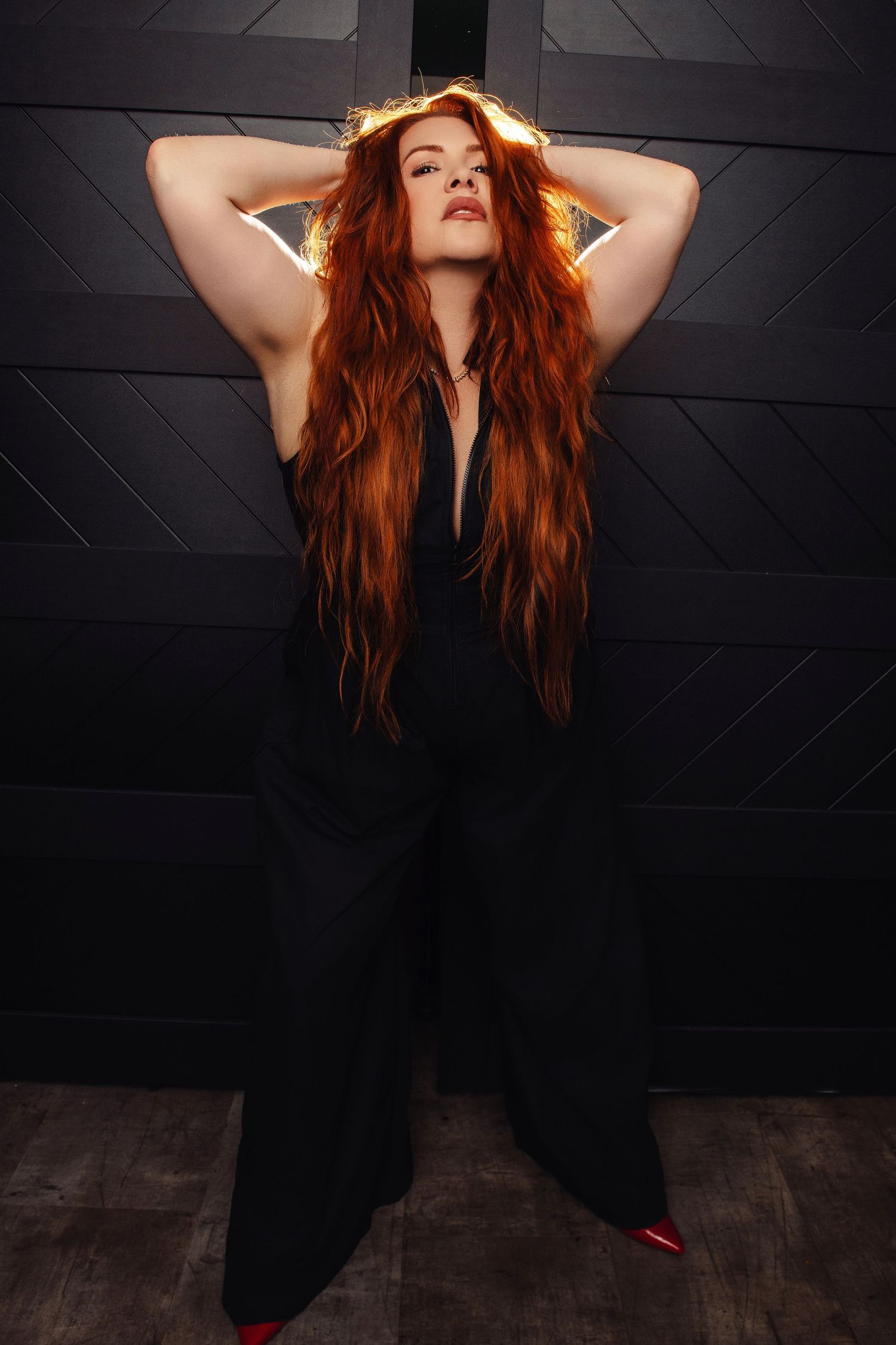 Artistic portraits with red hair movement against dark geometric background.