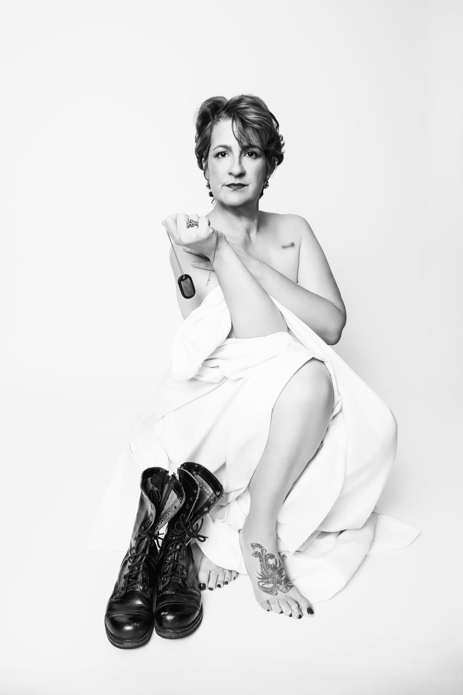 Artistic black and white portrait series featuring minimalist poses against white background. Celebrating female veterans and sexual assault