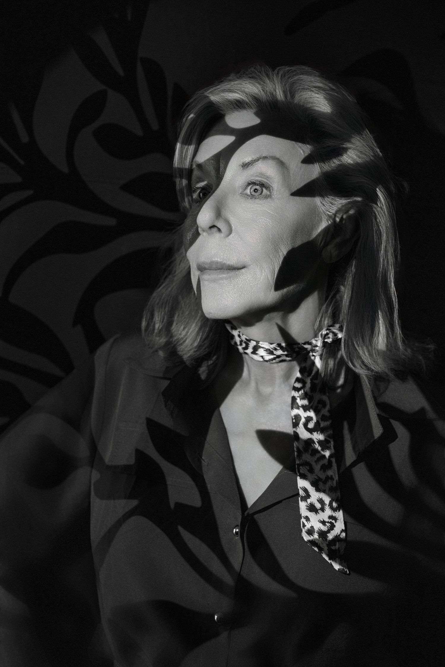 Dramatic black and white photo series with moody lighting and a leopard print scarf.