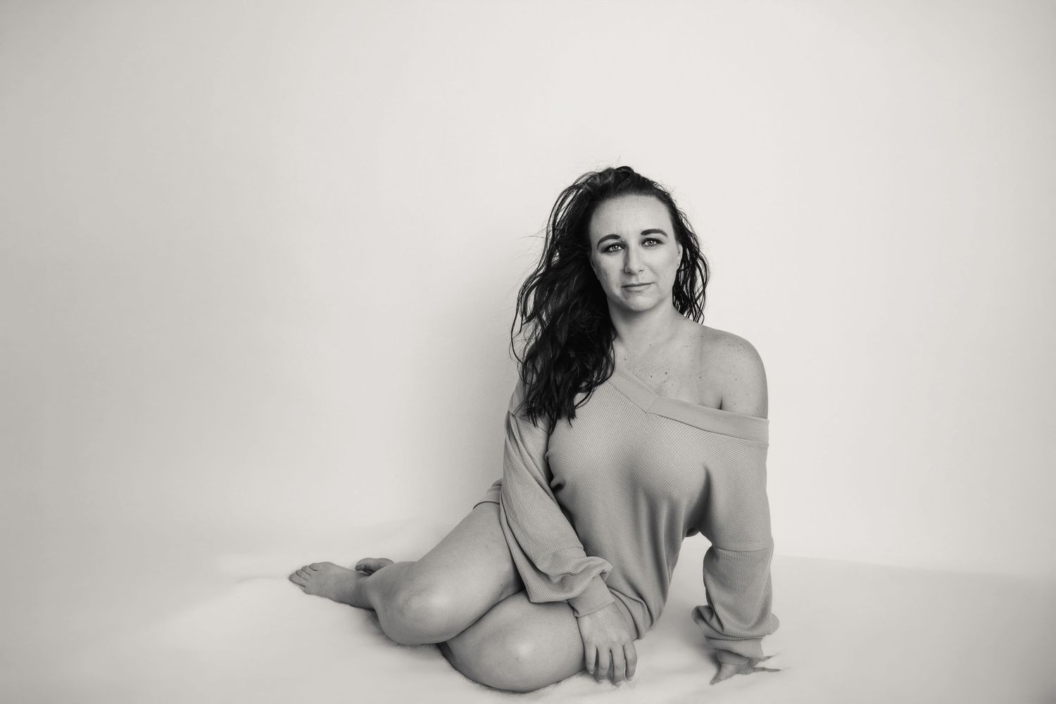 Intimate portrait series featuring soft poses and natural lighting on white backdrop.