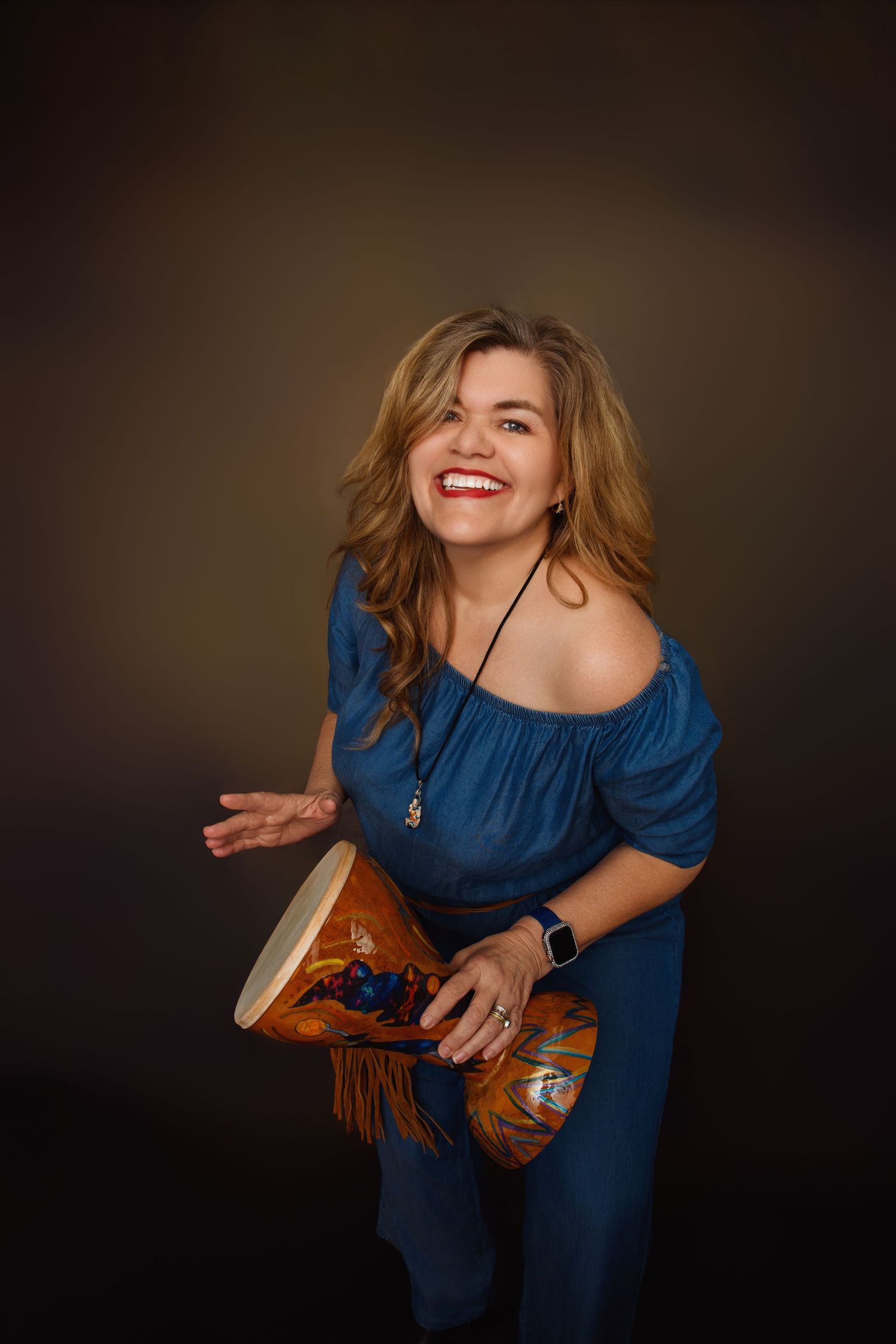 Expressive performance with percussion instrument in flowing blue outfit.