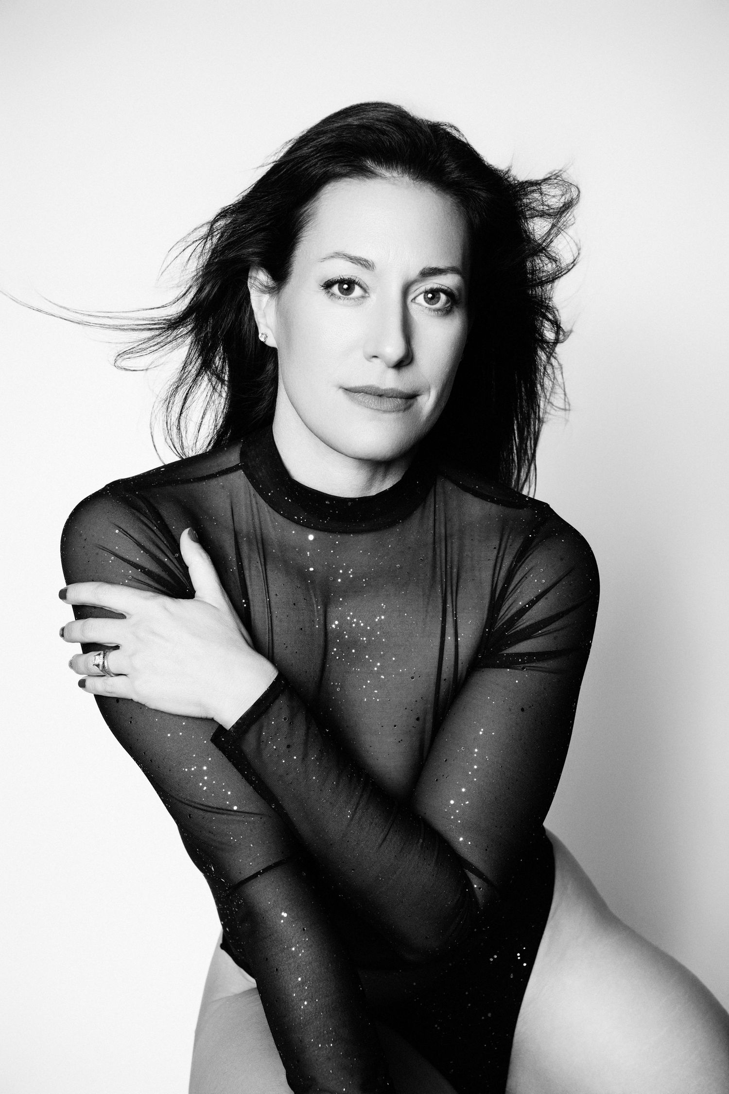 Artistic portrait series with sheer fabric and sparkle details in black and white.