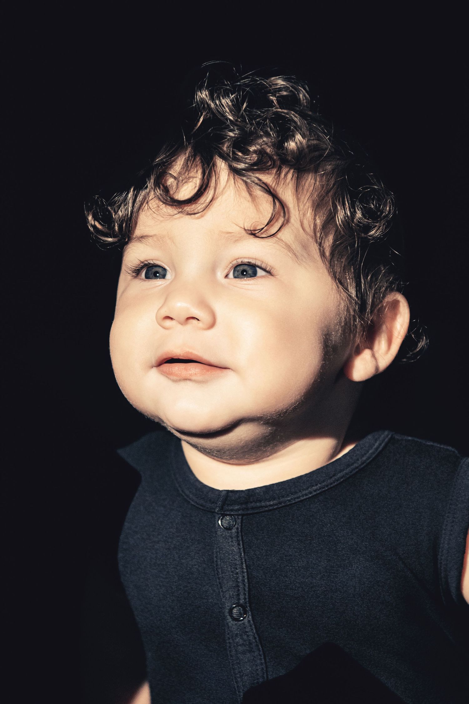 Series of intimate portrait shots with dramatic lighting and dark background.