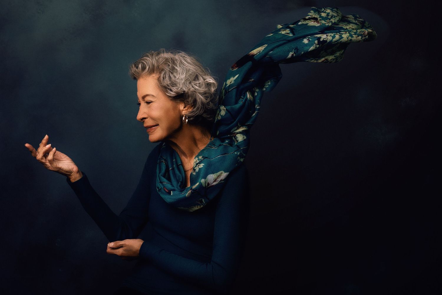 Dynamic motion portraits with flowing fabric against dark dramatic background.
