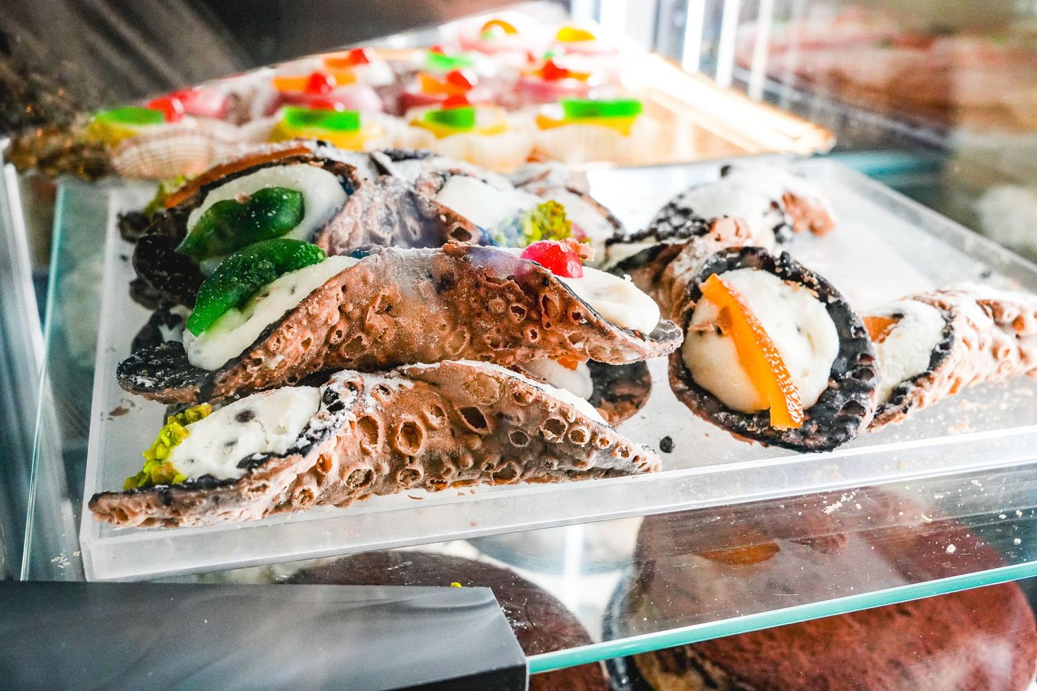 Fresh sushi and seafood displayed on ice in a glass deli case.
