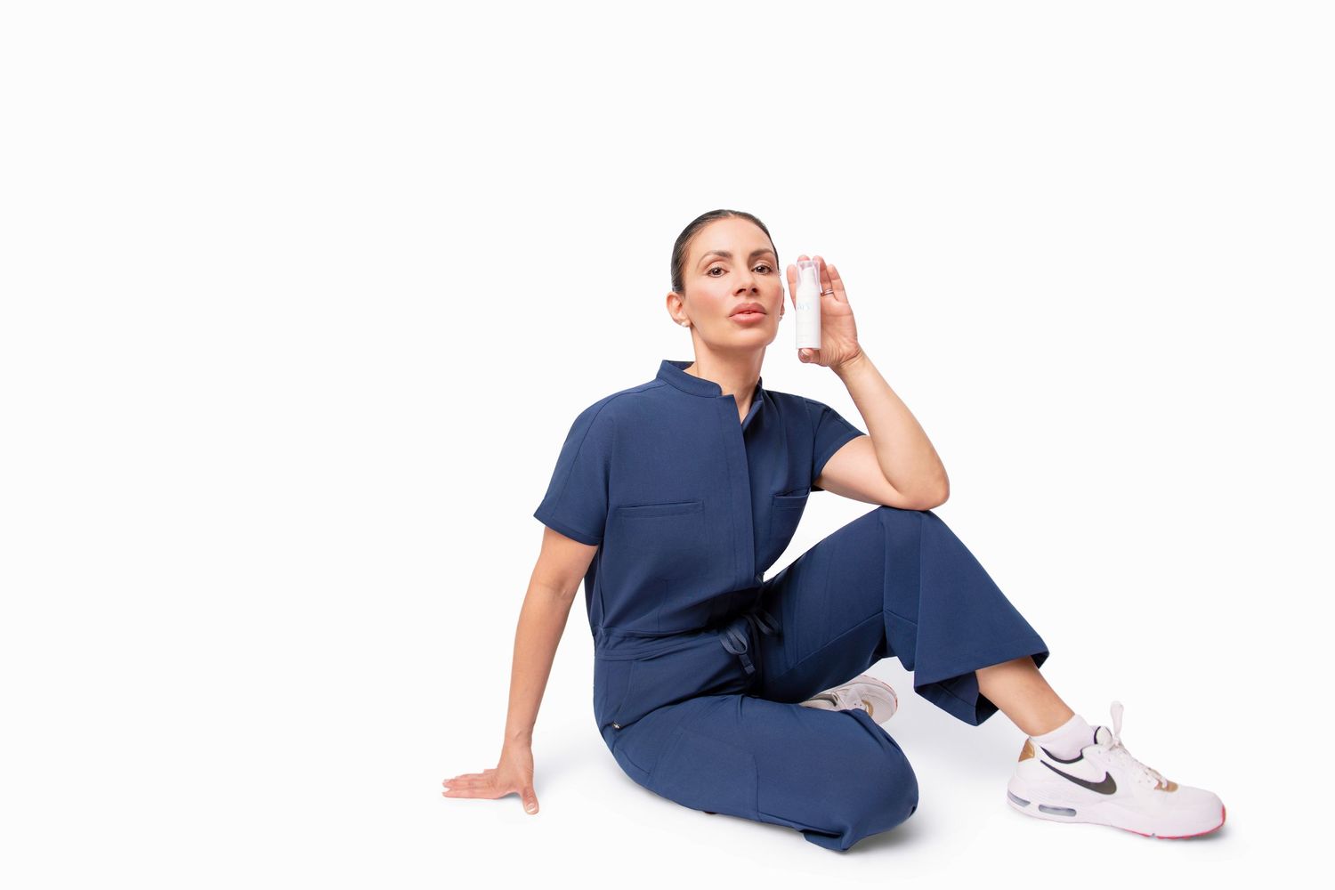 Person in navy blue outfit striking various casual poses on white background.
