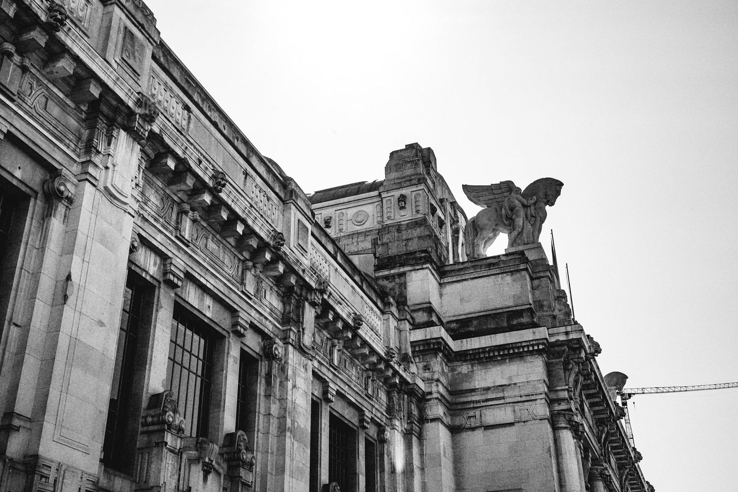Classical stone building facade with ornate architectural details shown in panoramic segments.