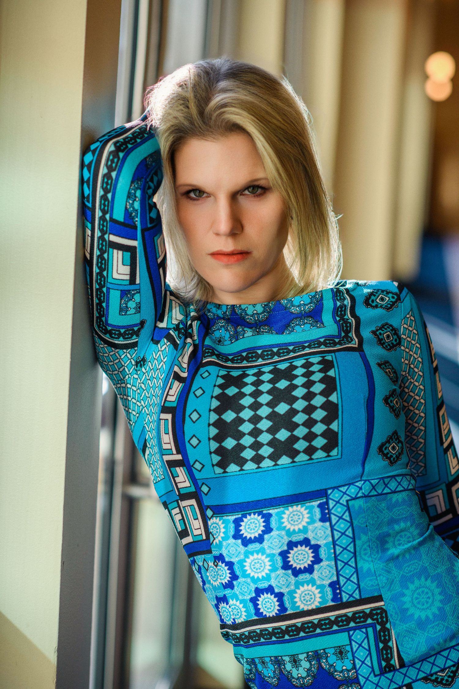 Portrait in geometric blue patterned dress with shoulder pad detail. Shot in Las Vegas, destination fashion shoot