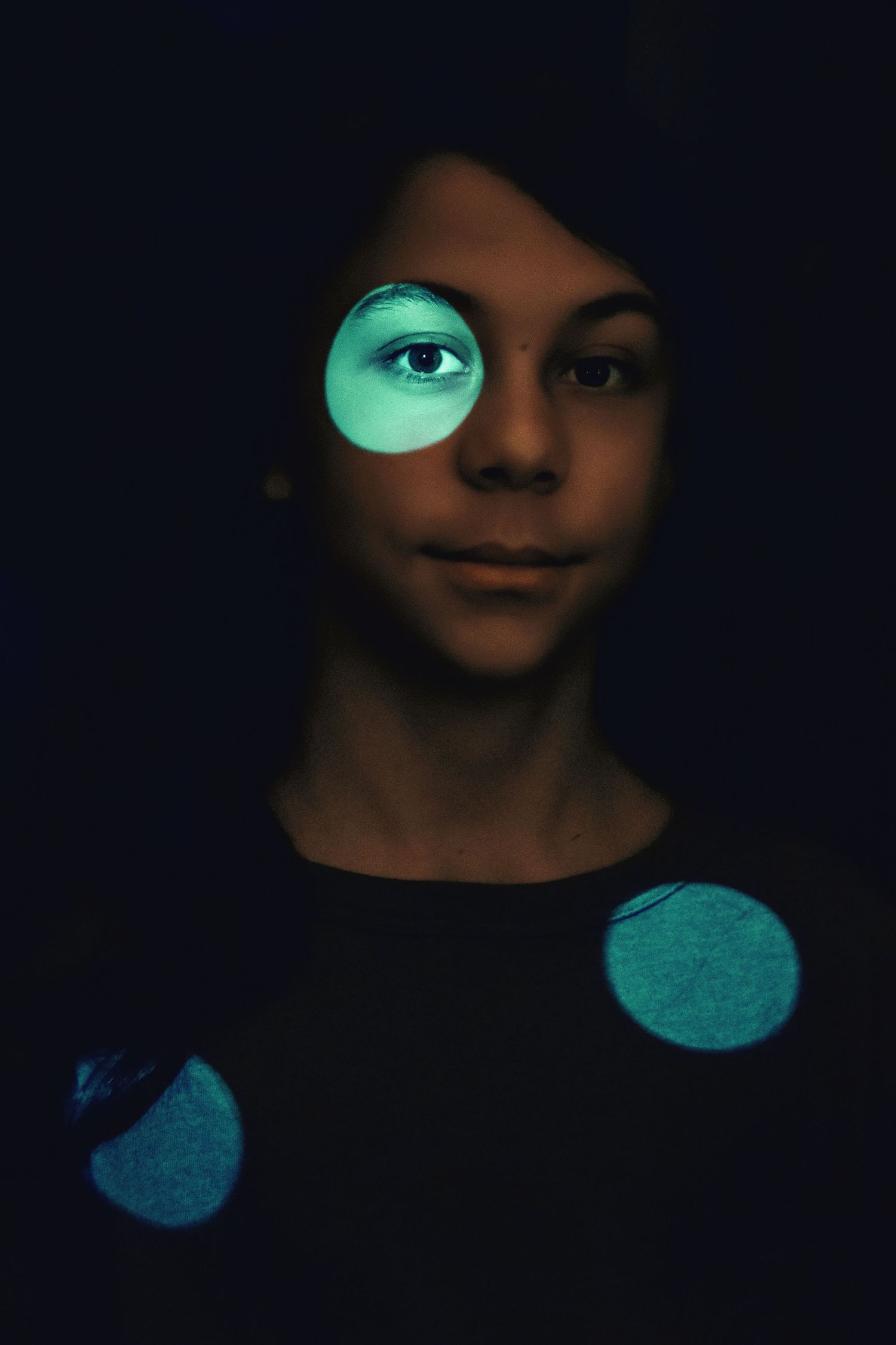 Dark portrait sequence with ethereal teal lighting effects.