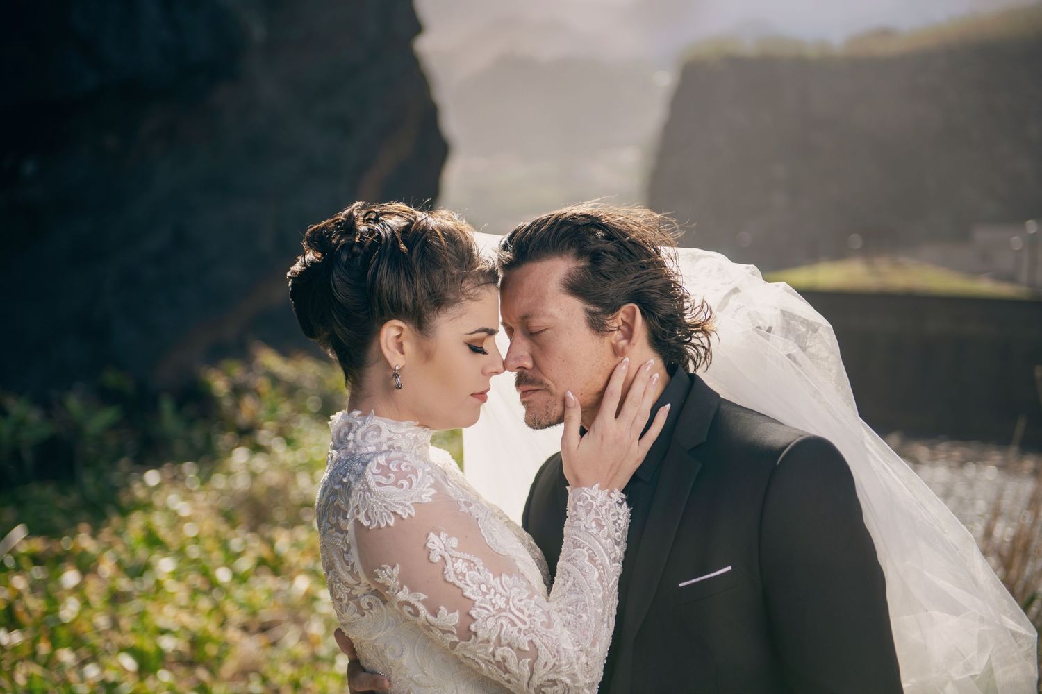 Wedding couple shares intimate embrace during outdoor photo session.