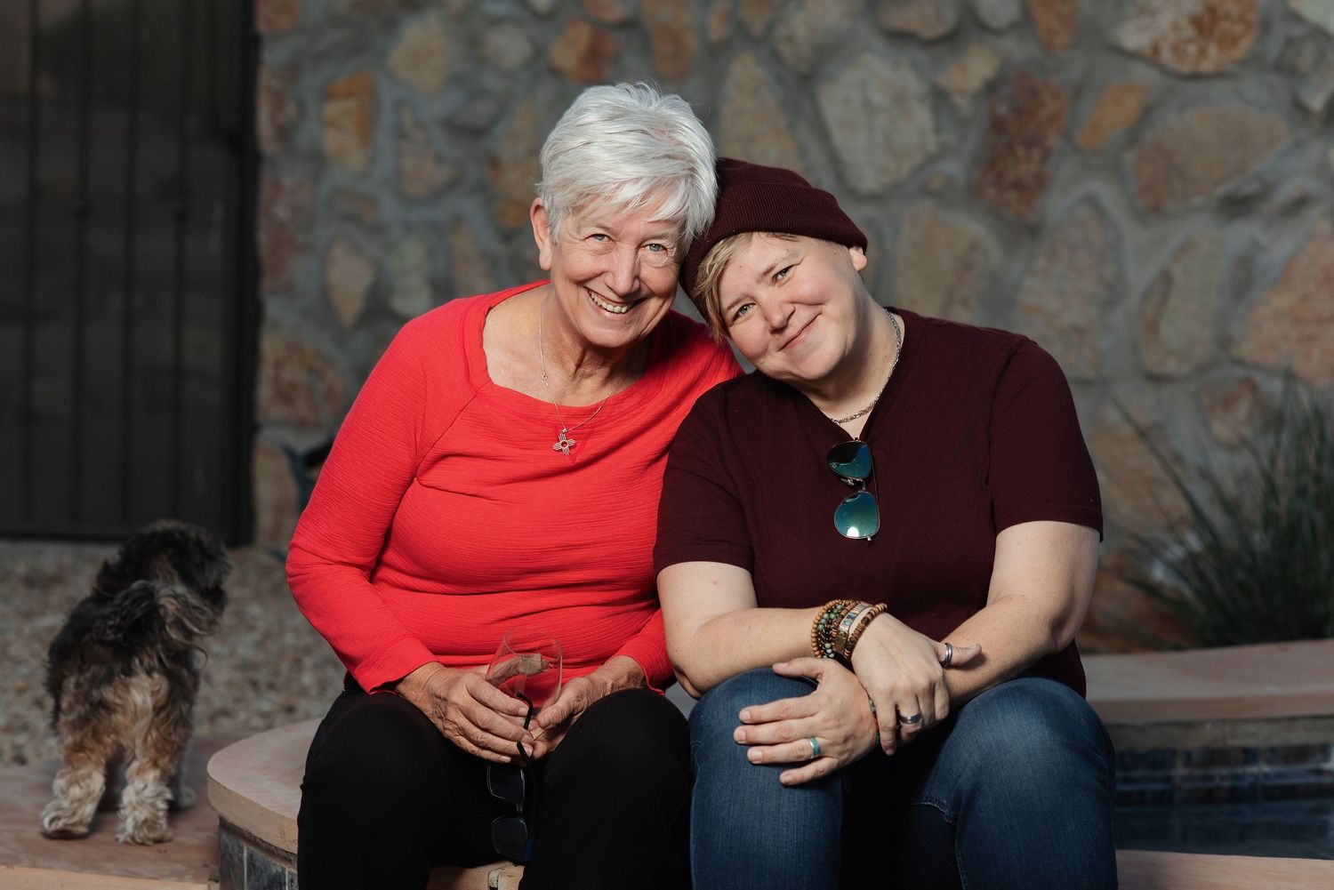Casual portrait session on stone steps with coordinated burgundy outfits.