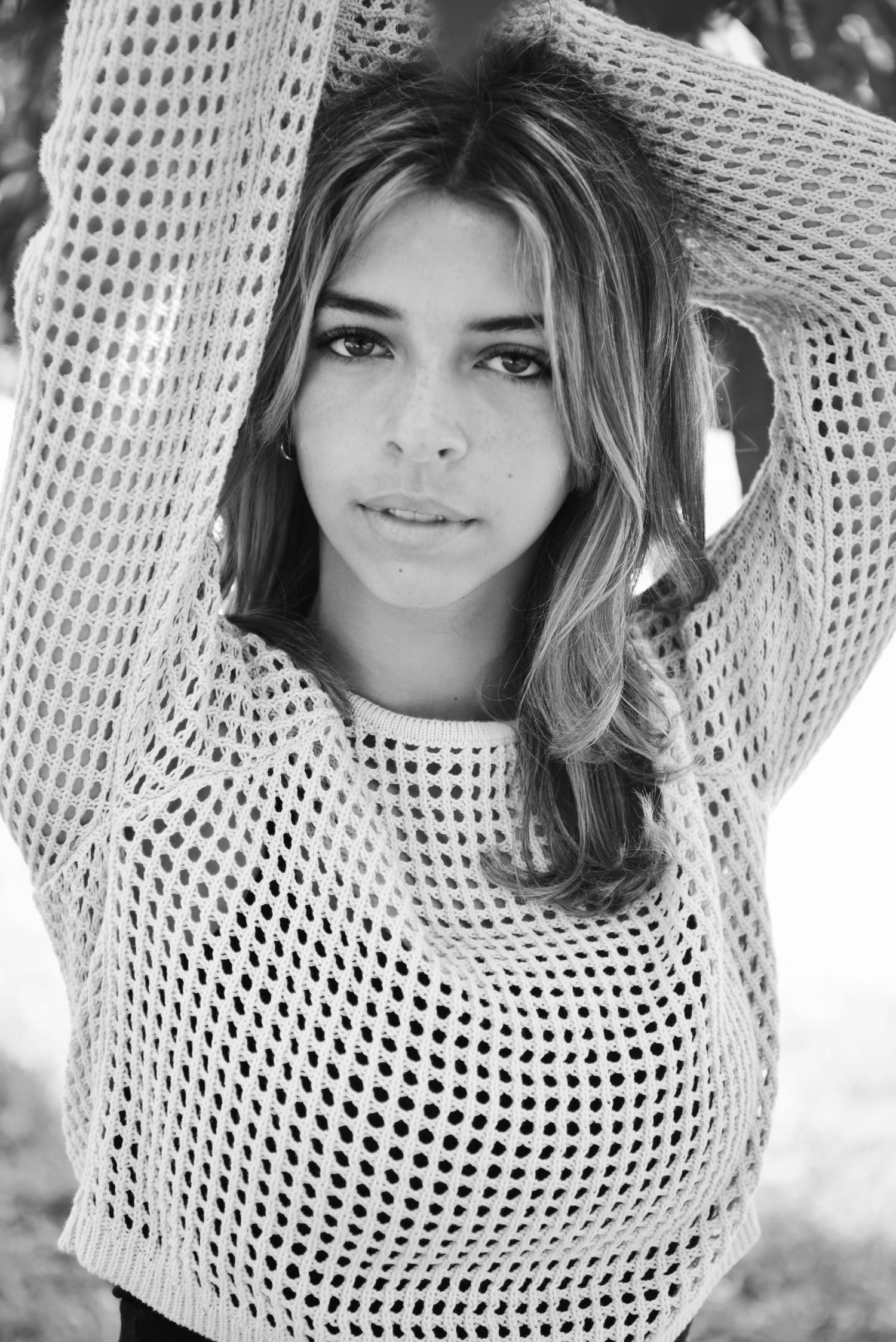 Black and white portrait series showing a woman in a white mesh top against a light background.