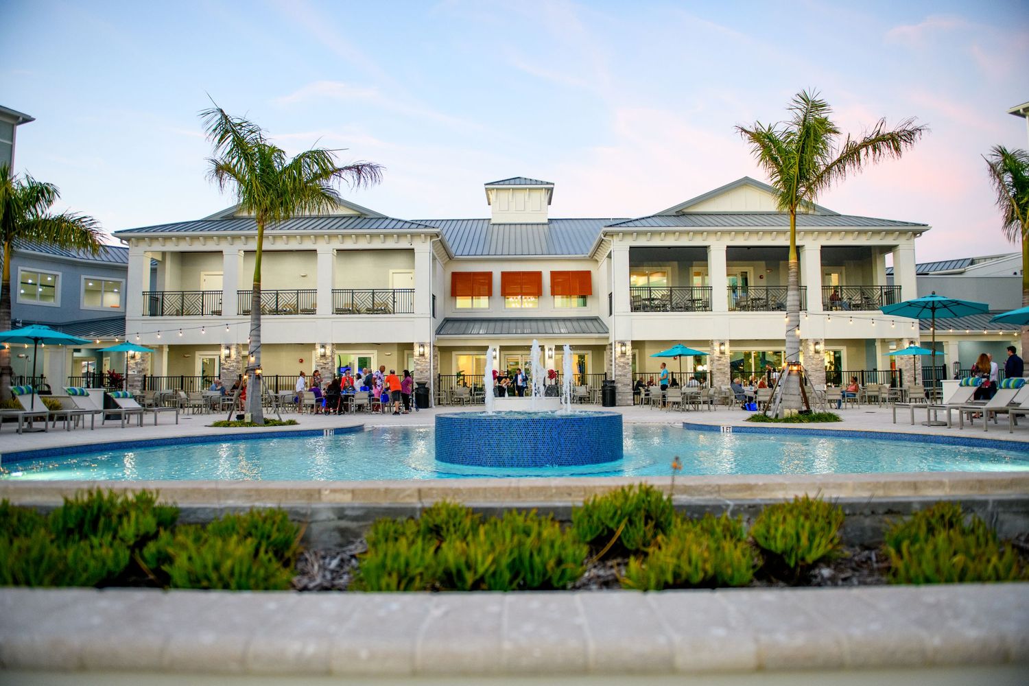 Panoramic view of beachfront hotel property with pool and palm trees.
