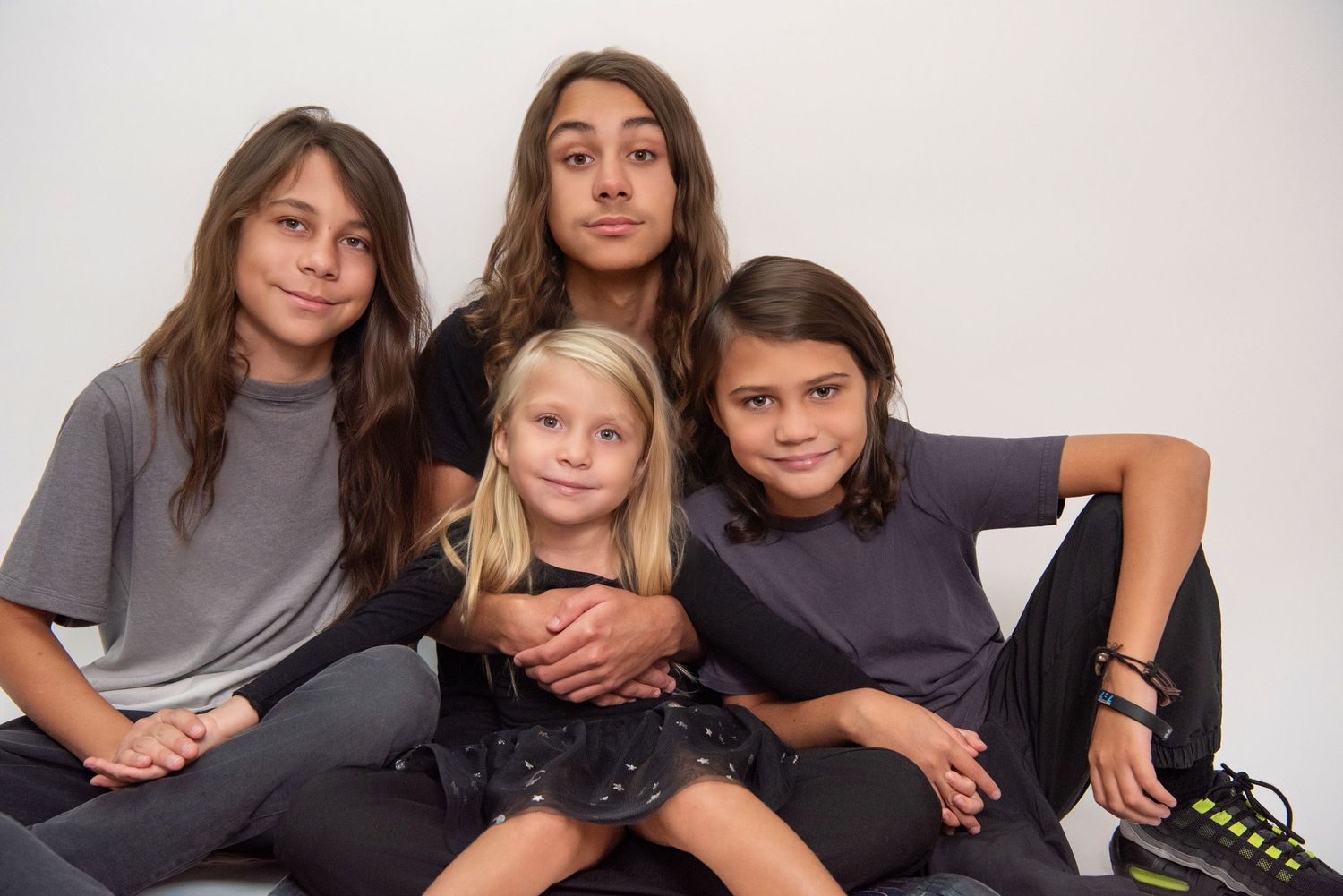 Studio portrait session showing different poses and expressions in casual clothing against white background.