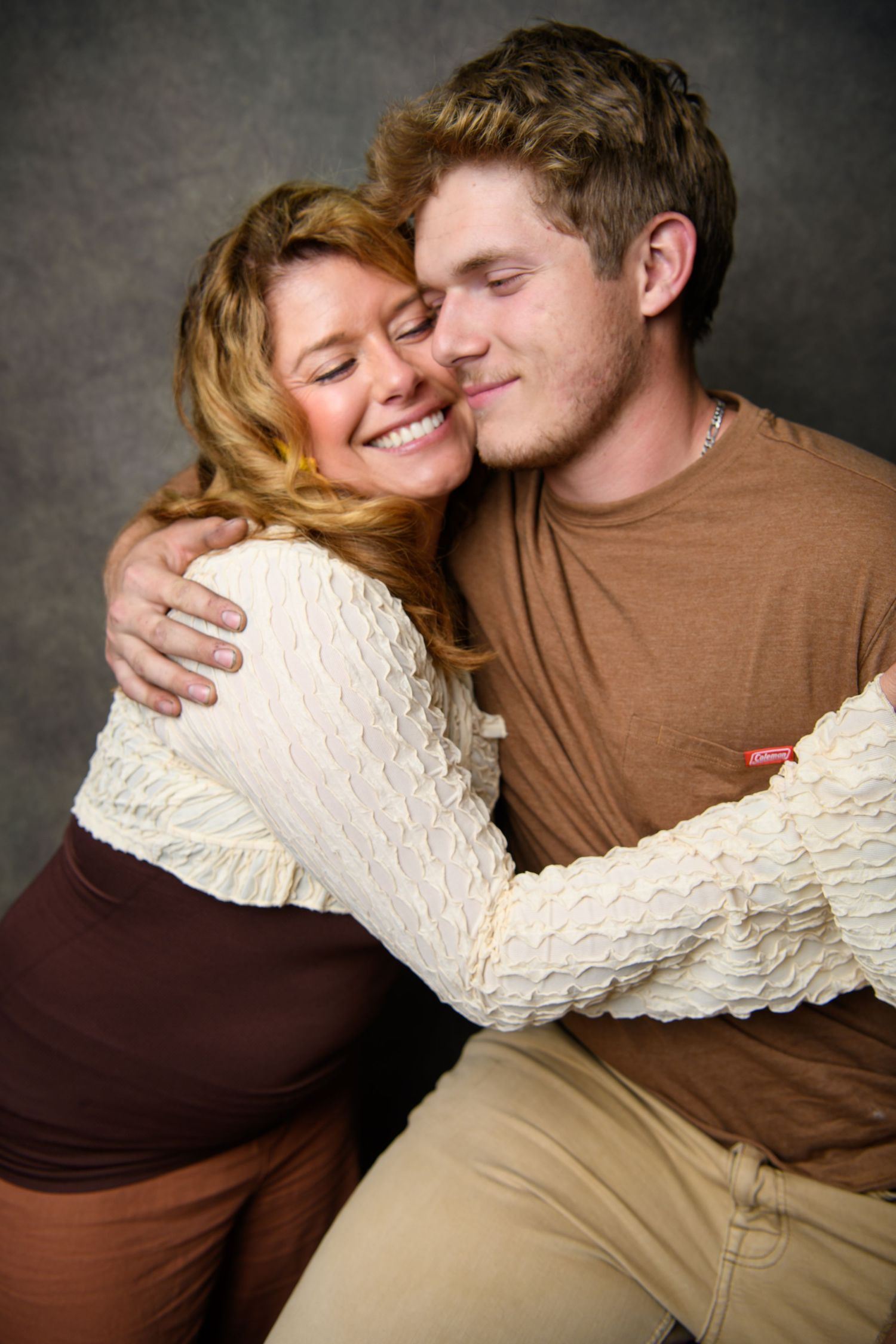 Intimate couple photos showing tender moments and embraces against dark backdrop.
