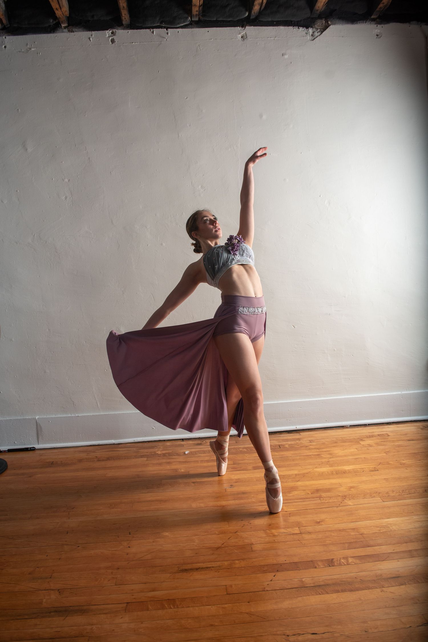 Dance performance sequence featuring spins and flowing fabric in a studio space.