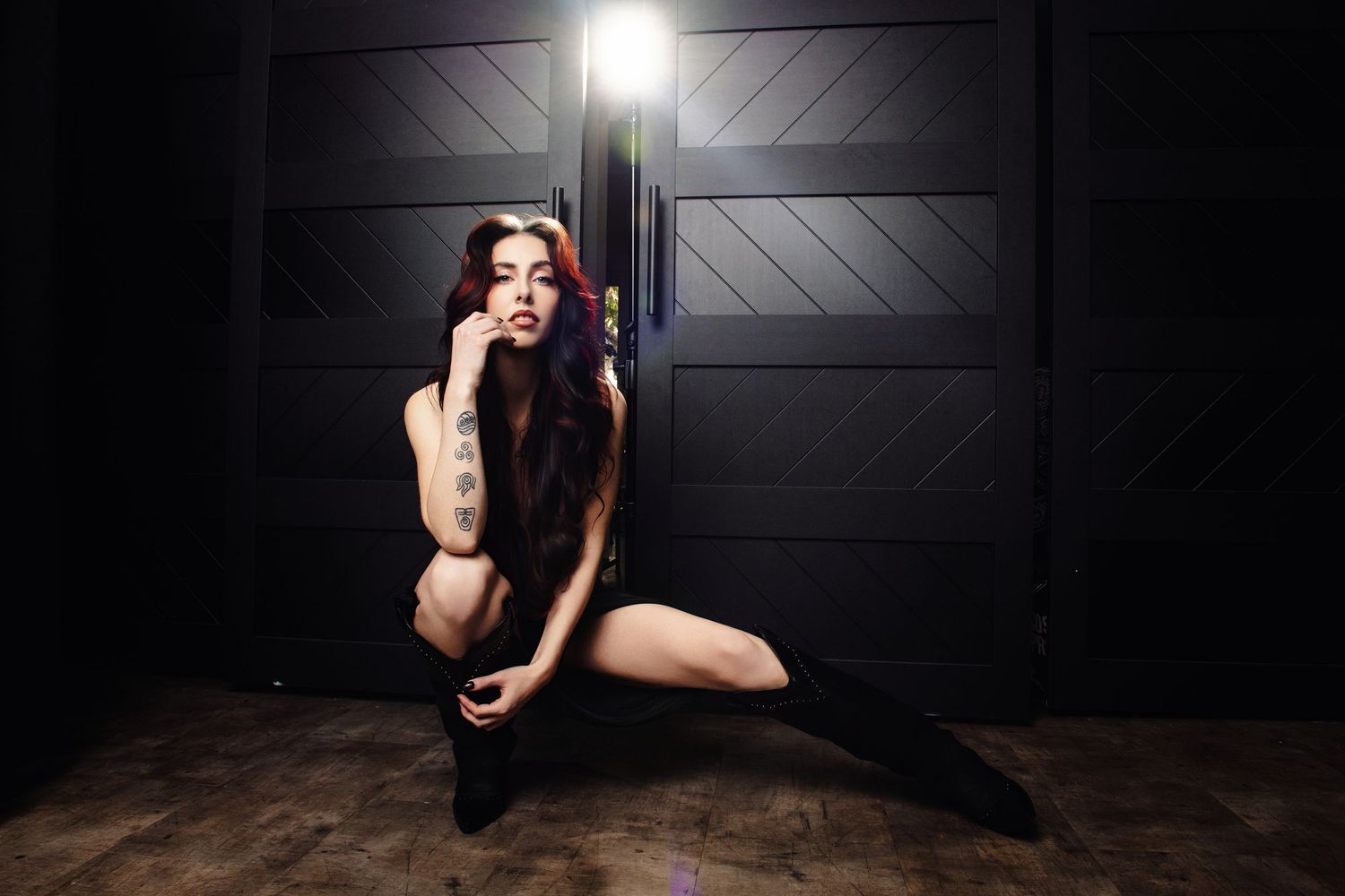 Artistic portrait series in dark room with dramatic lighting and poses.