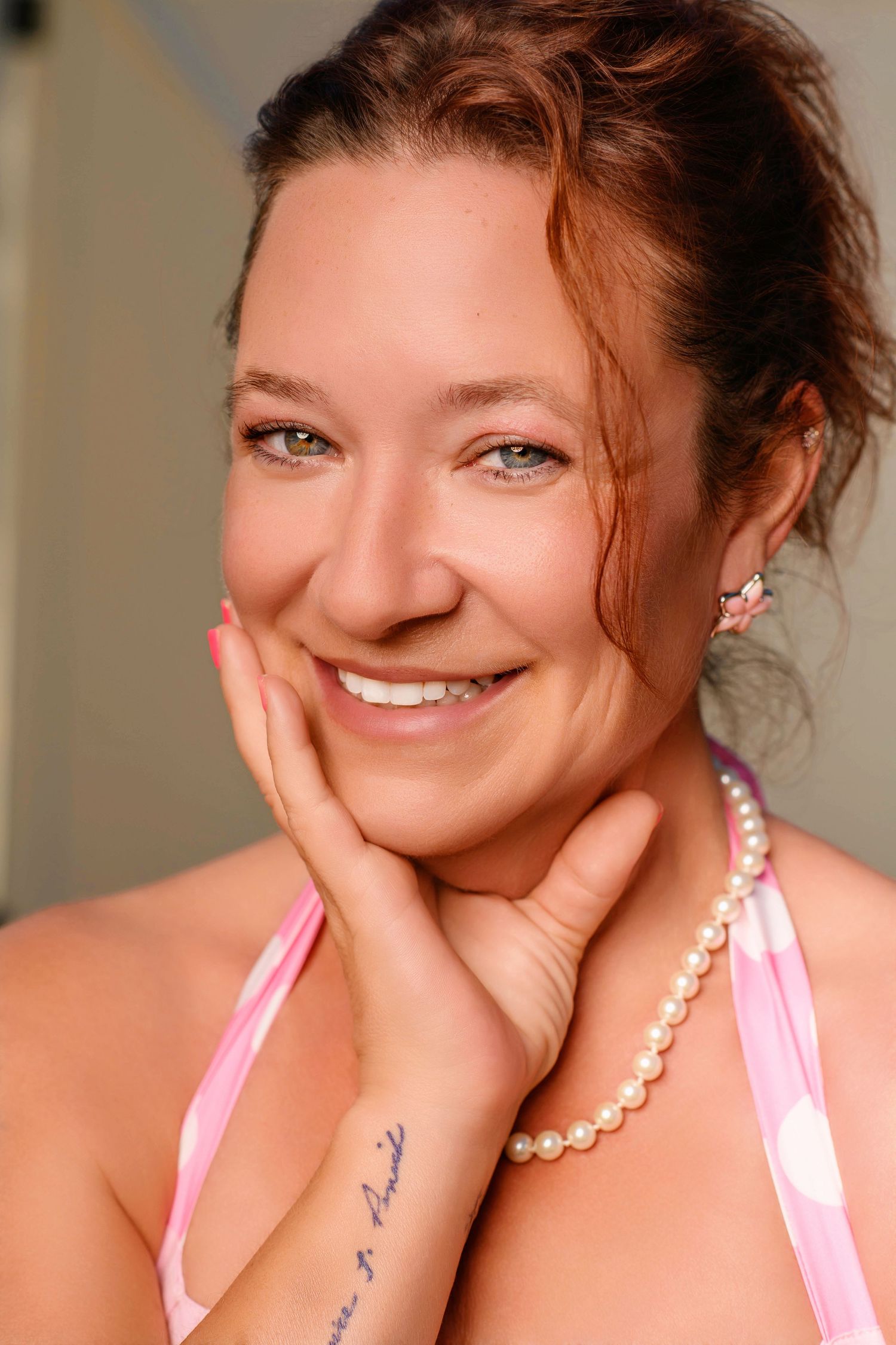 Intimate portrait series featuring pearl necklace and pink top with natural lighting.