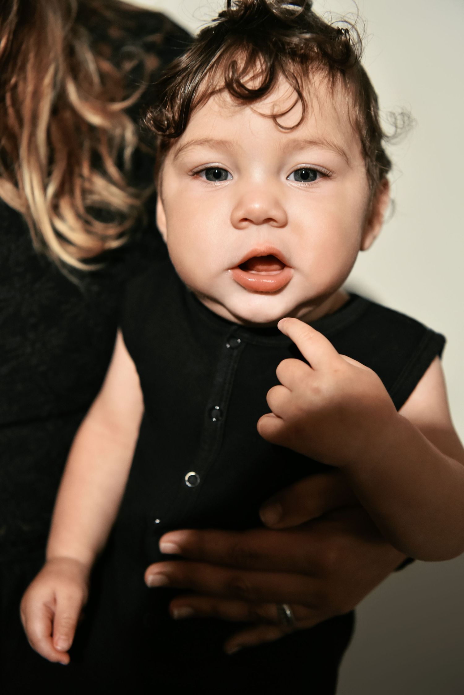 Portrait series with gentle hand gestures and dark clothing.