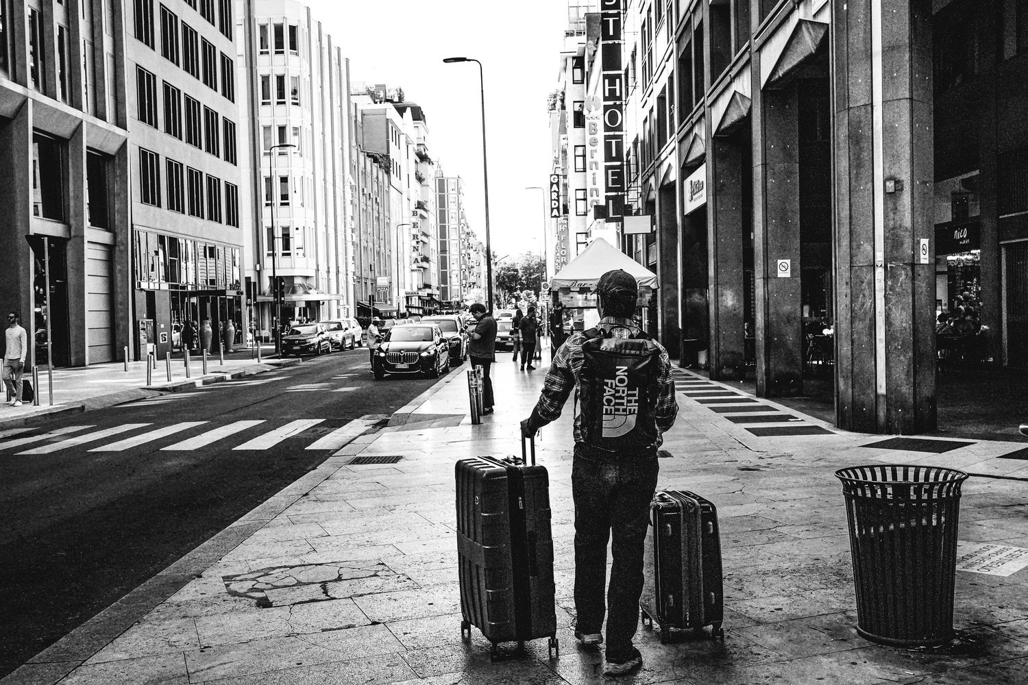 Black and white urban street scenes showing empty sidewalks and modern city architecture.