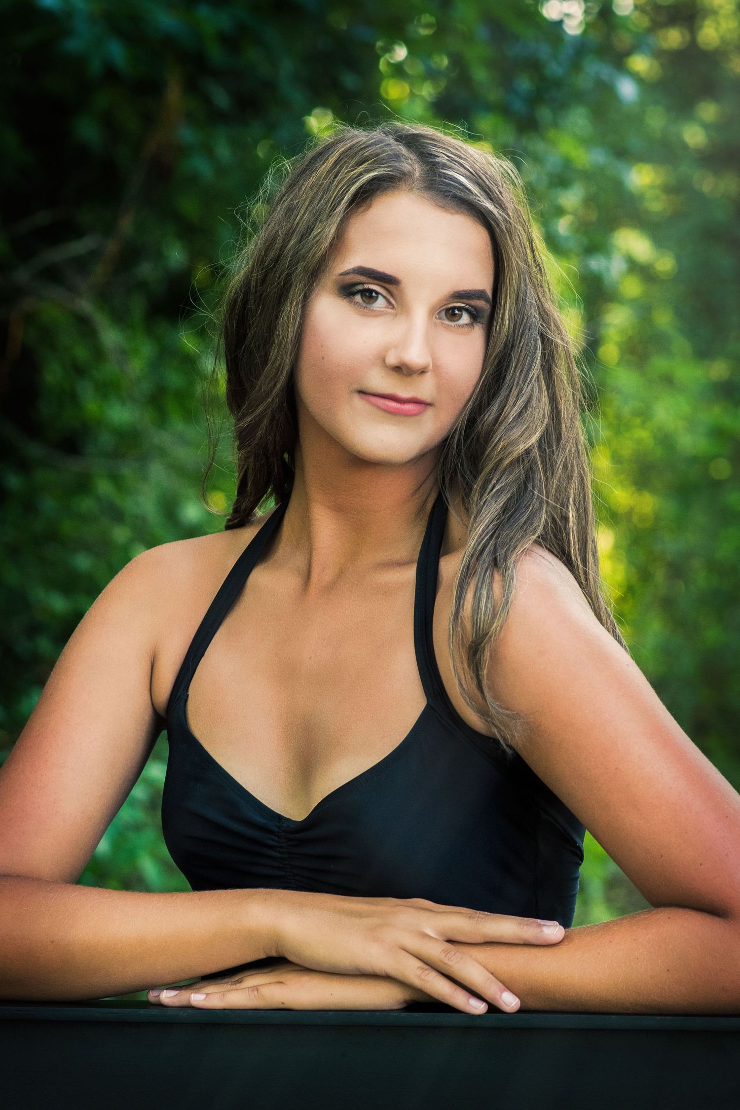 Artistic portrait sequence showing relaxed poses against blurred green outdoor backdrop.