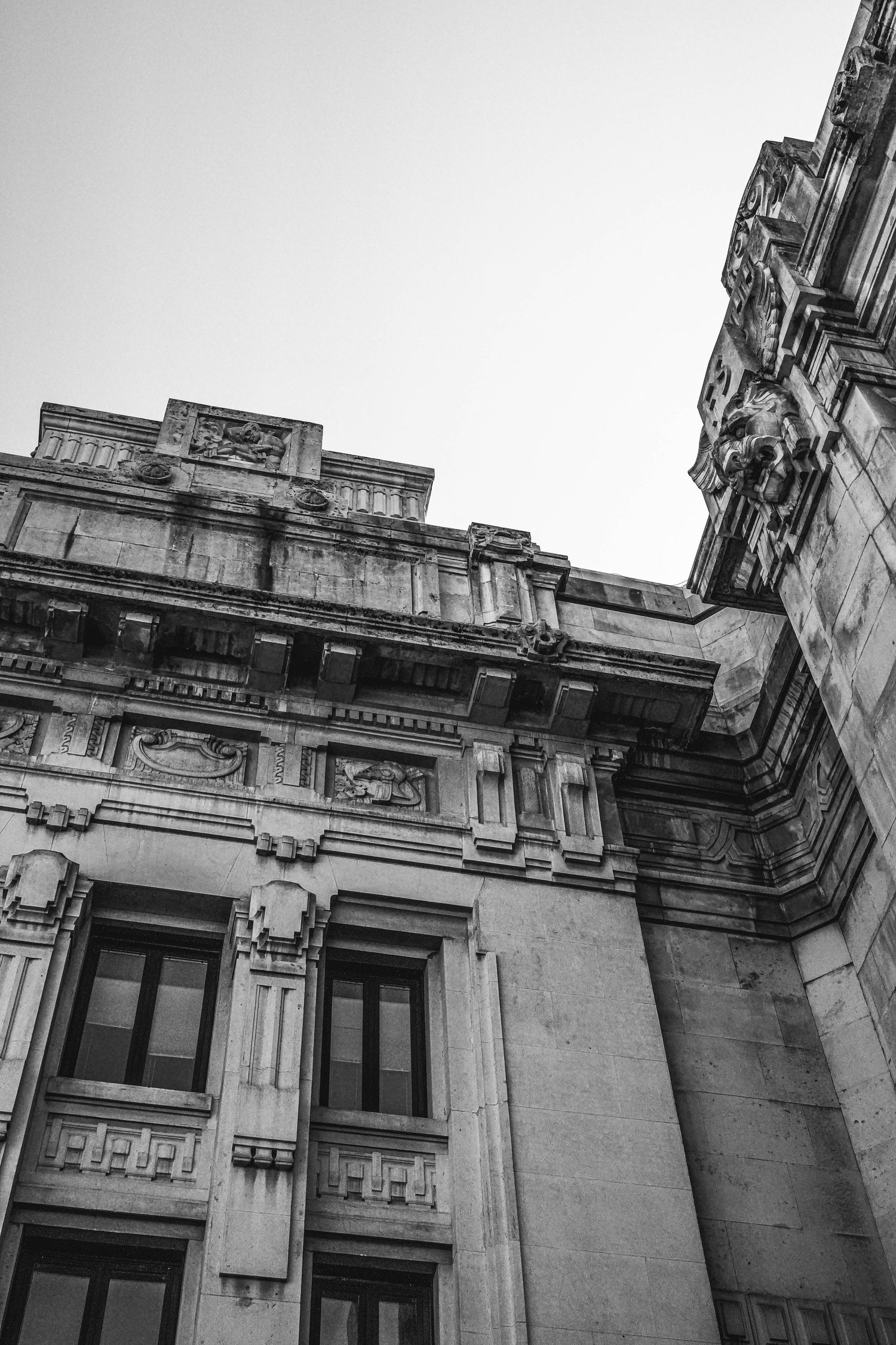 Black and white architectural photo showing the detailed facade of a historic building.