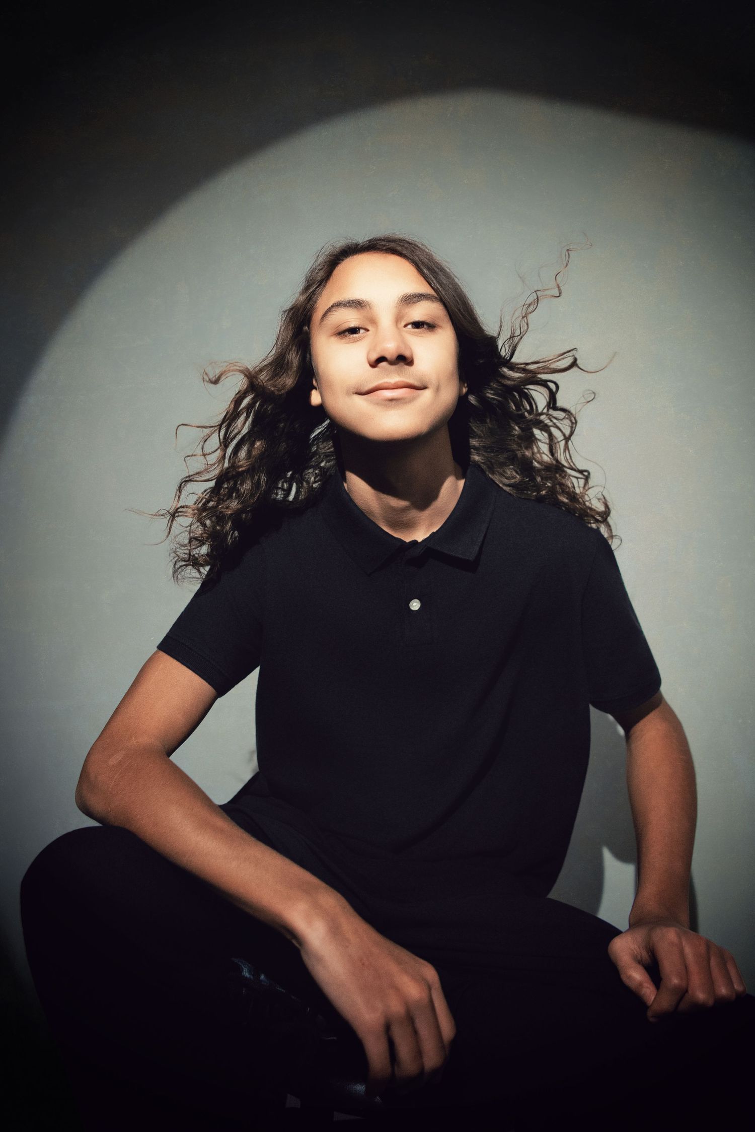 Artistic portrait series showing dynamic movement and flowing hair against dark background.