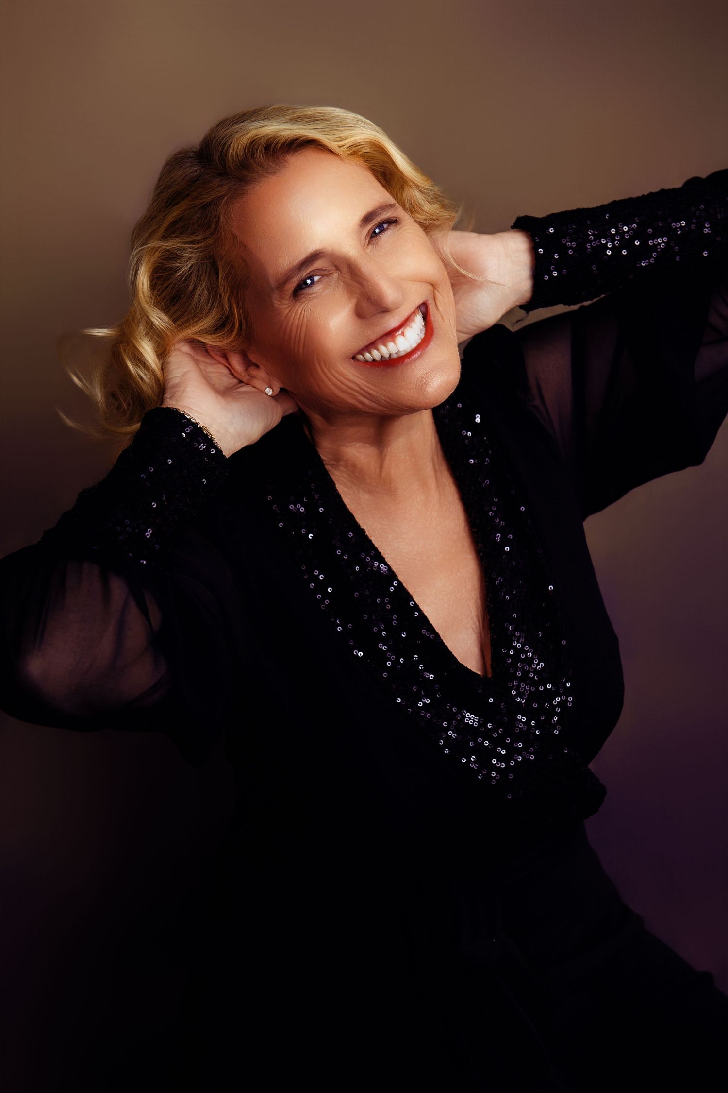Professional portrait series featuring sparkly black evening wear against dark background.
