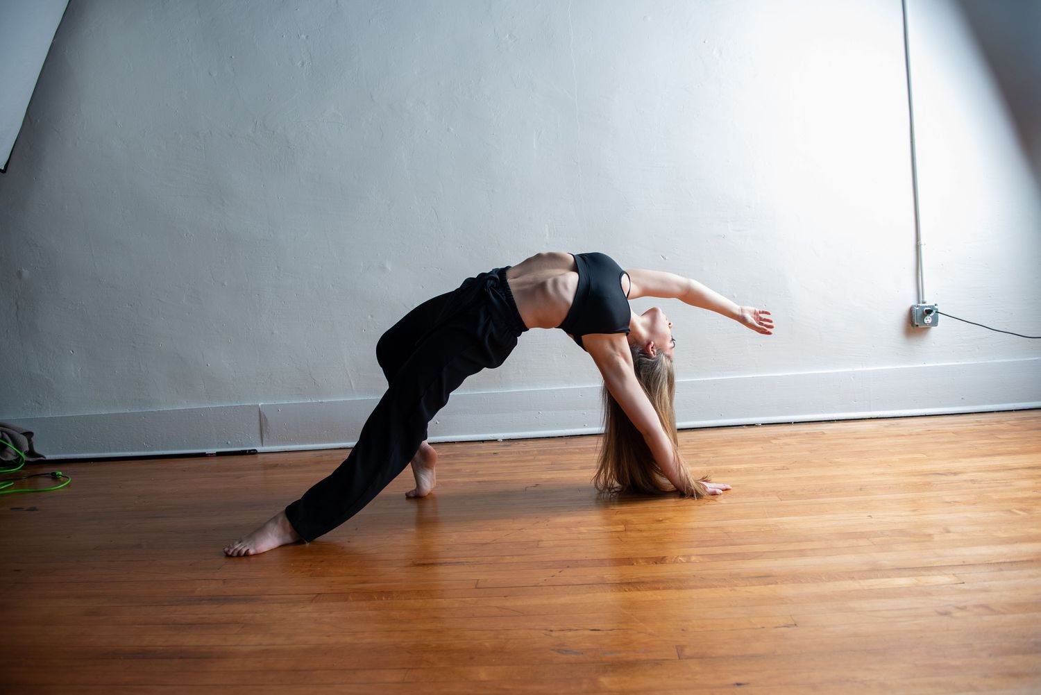 Contemporary dance movements captured in a flowing sequence on hardwood flooring.