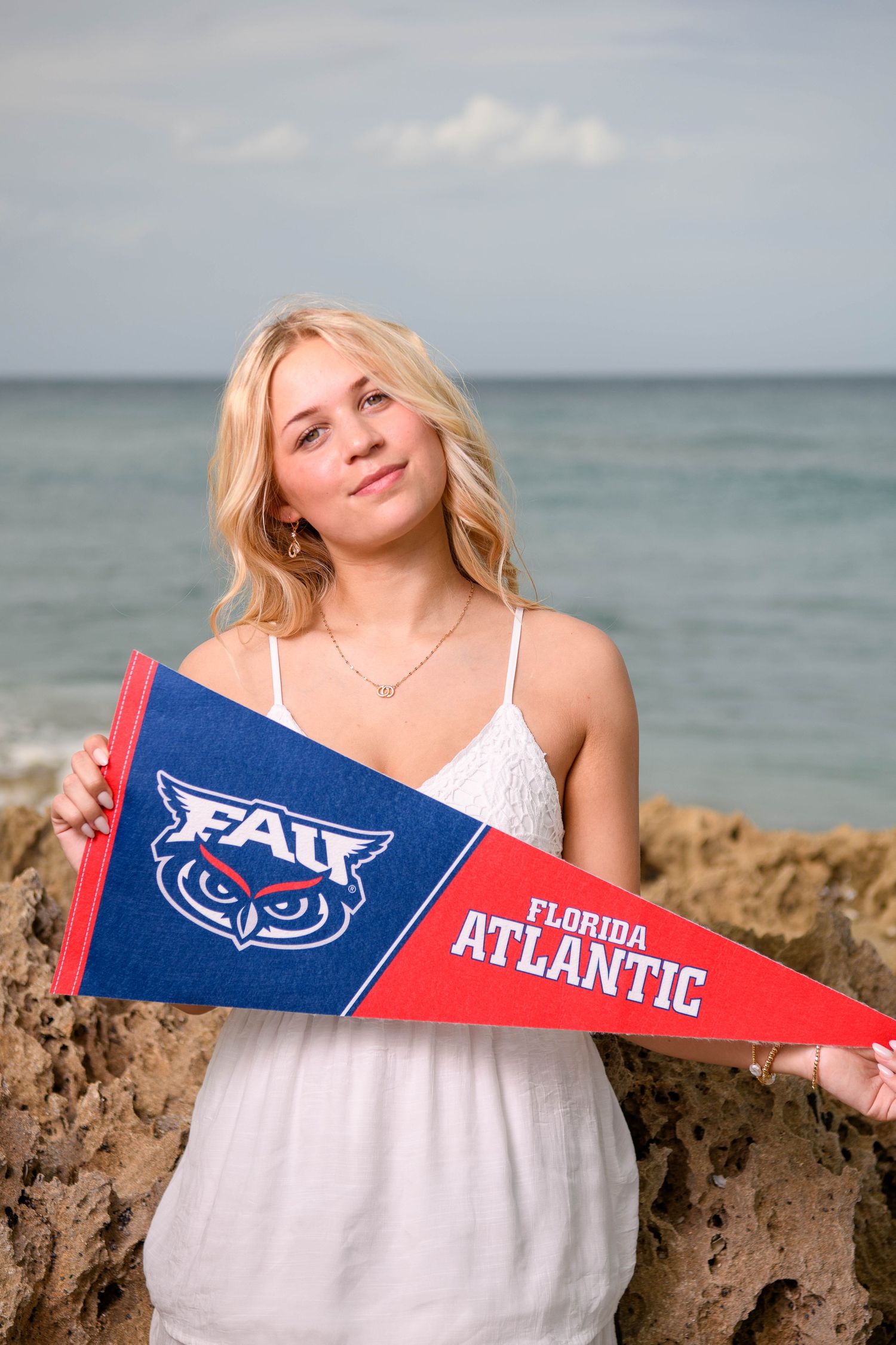 A series of beach photos showing FAU college pennants against a rocky coastal backdrop and ocean view.