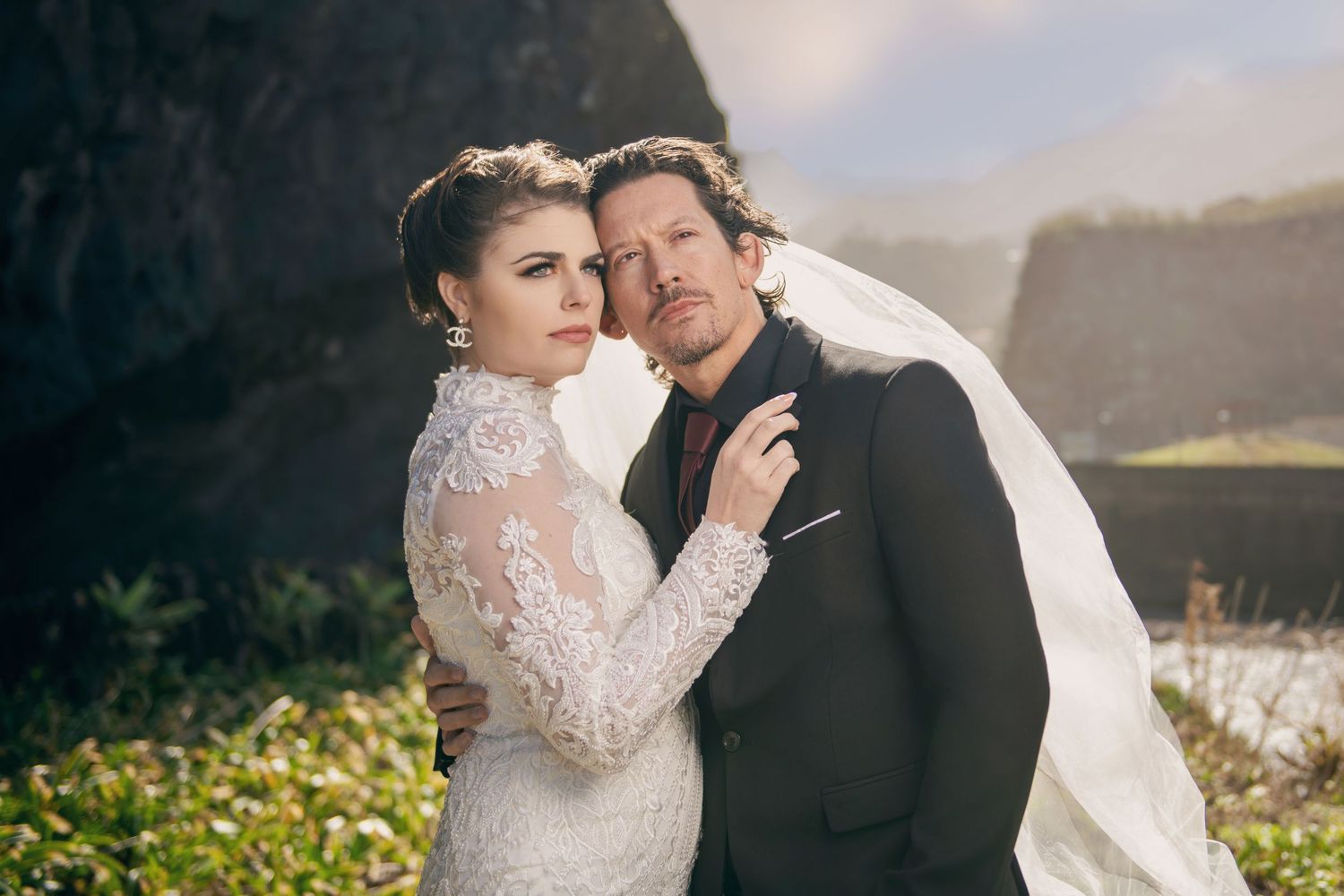 Bride and groom share intimate moment during coastal wedding photoshoot.
