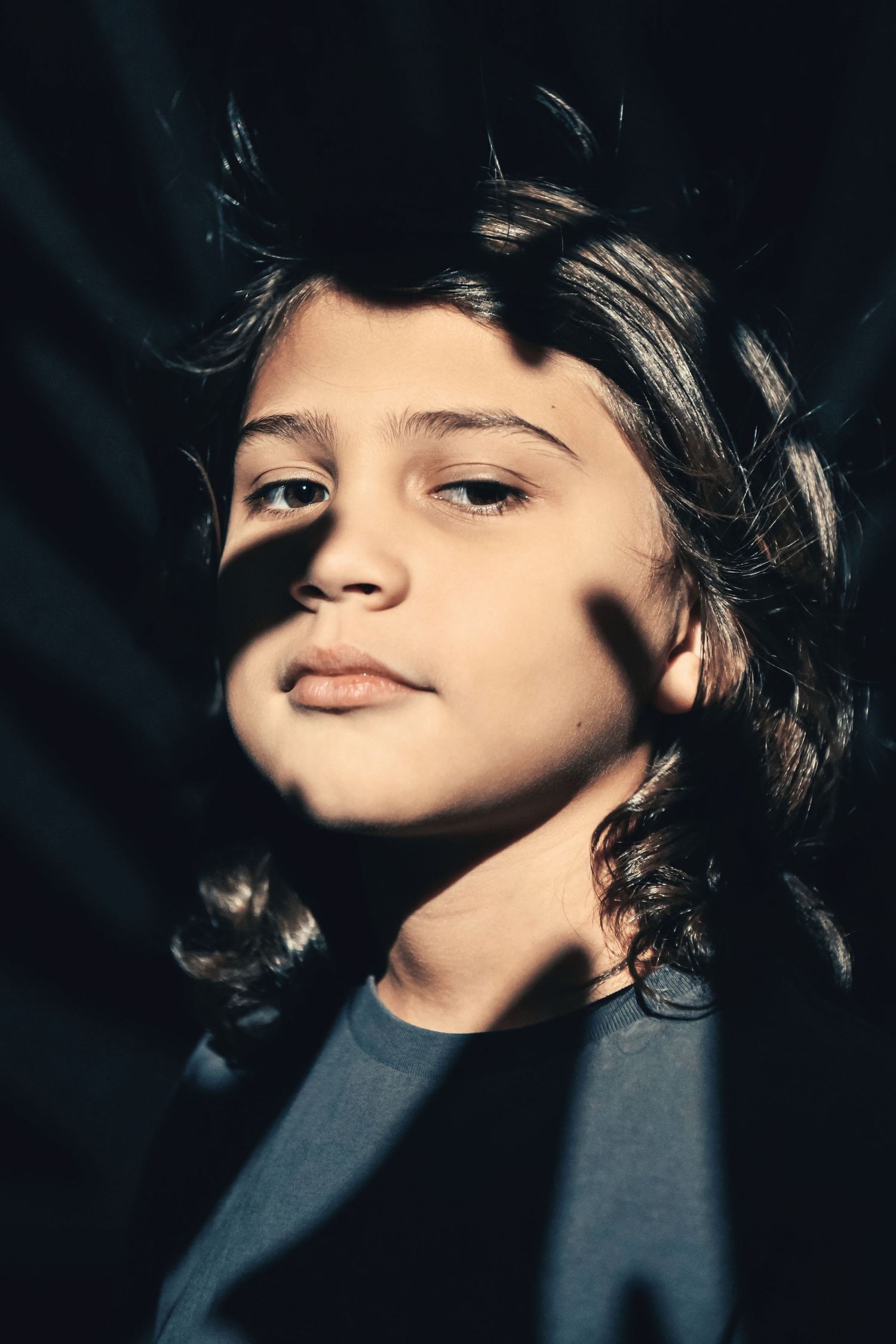 Artistic close-up portraits with dramatic side lighting and shadows.