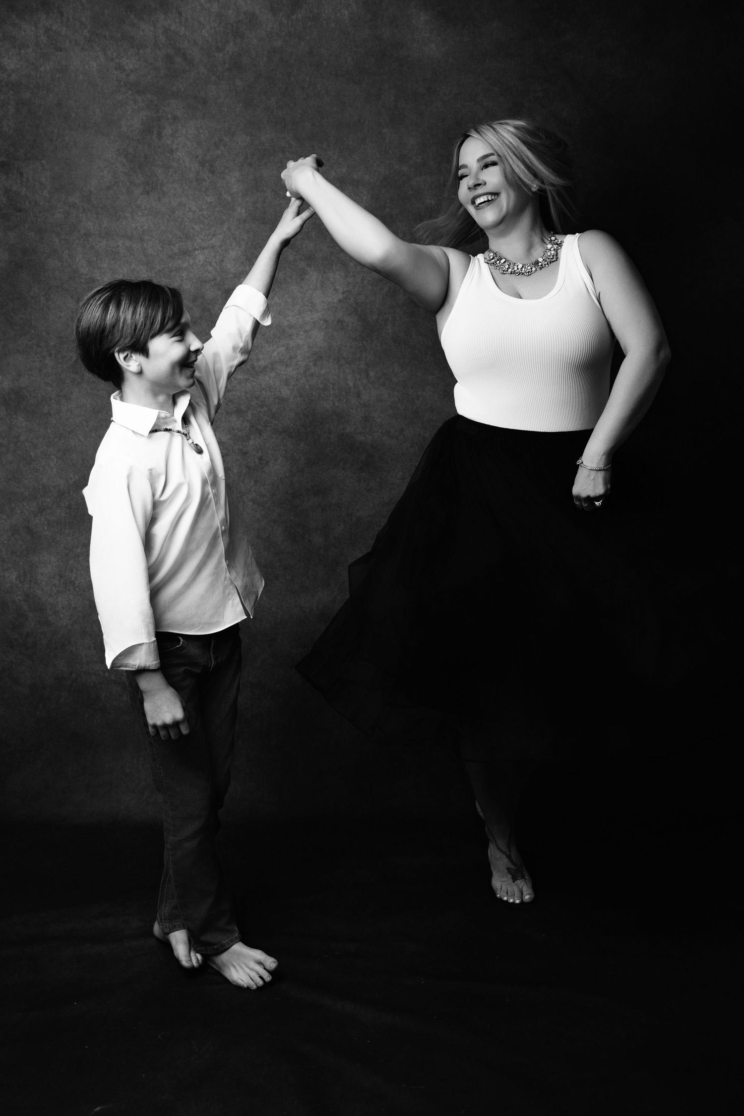 A black and white artistic portrait series showing playful interaction between family members.